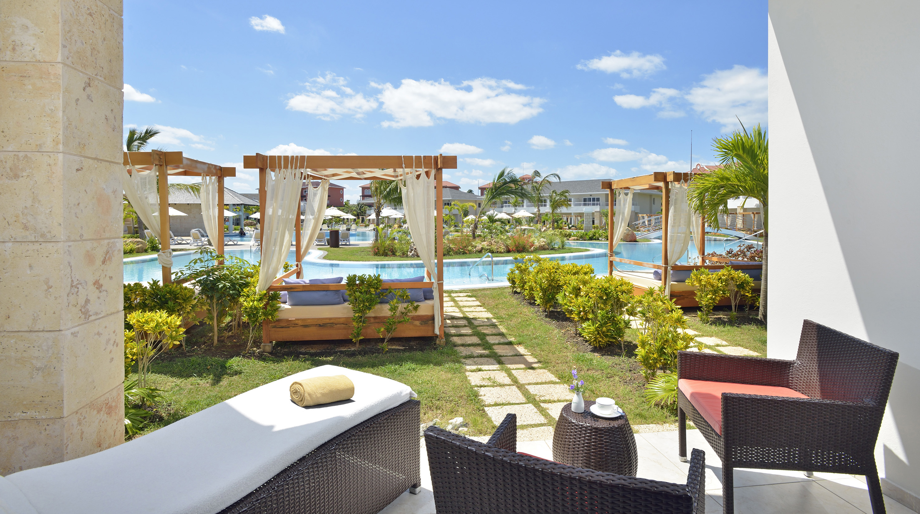 a pool with chairs and a bed