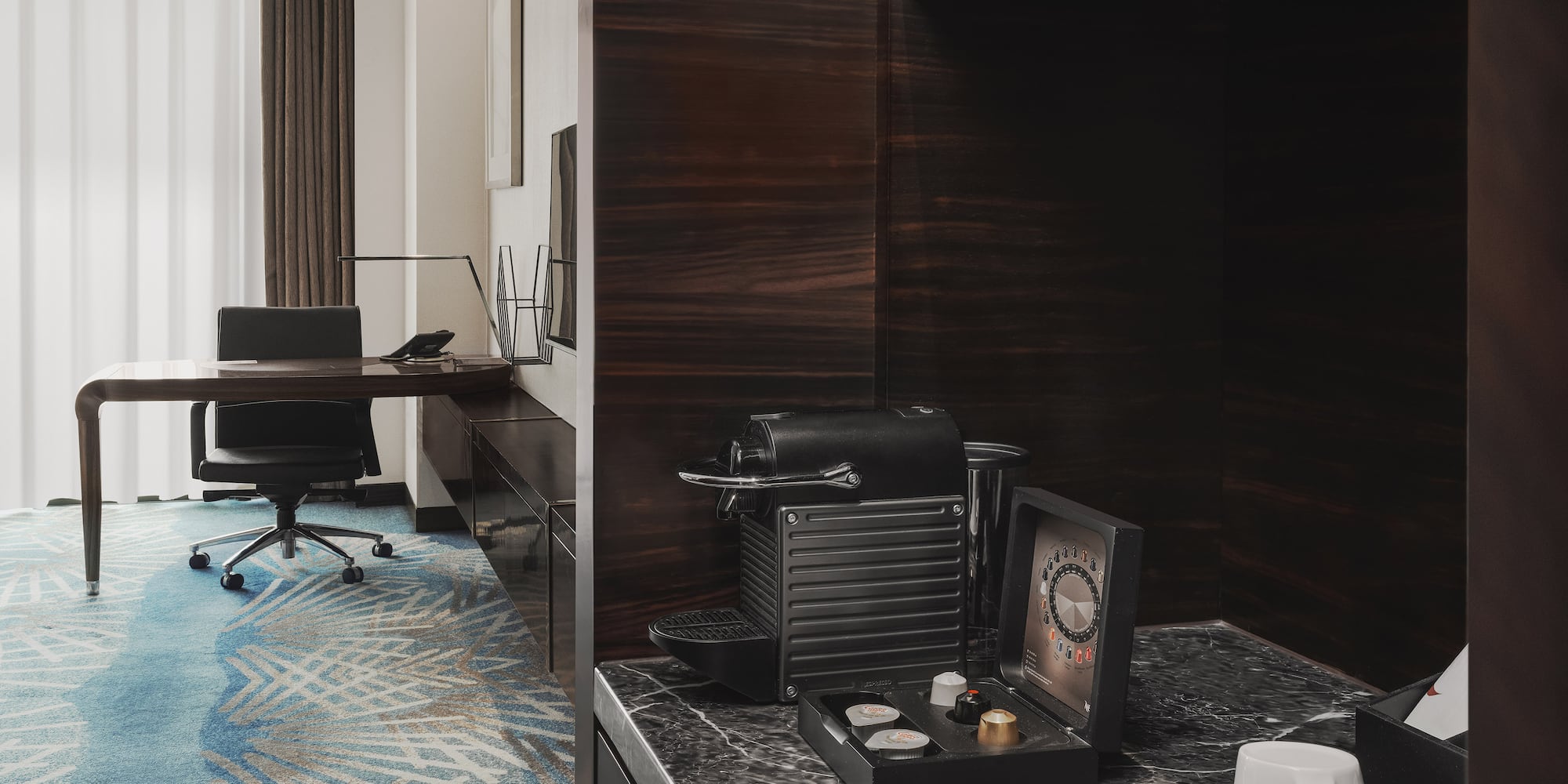 a room with a desk and a coffee machine