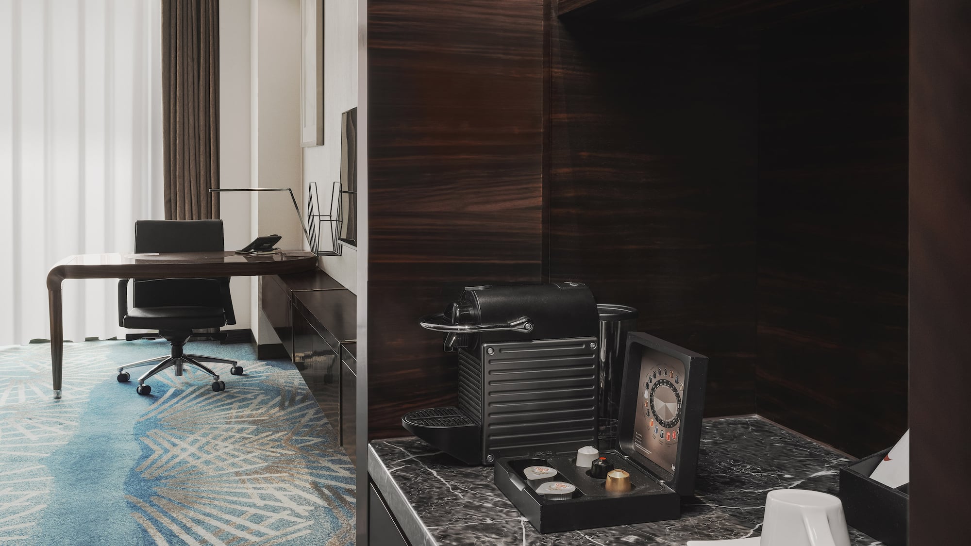 a room with a desk and a coffee machine