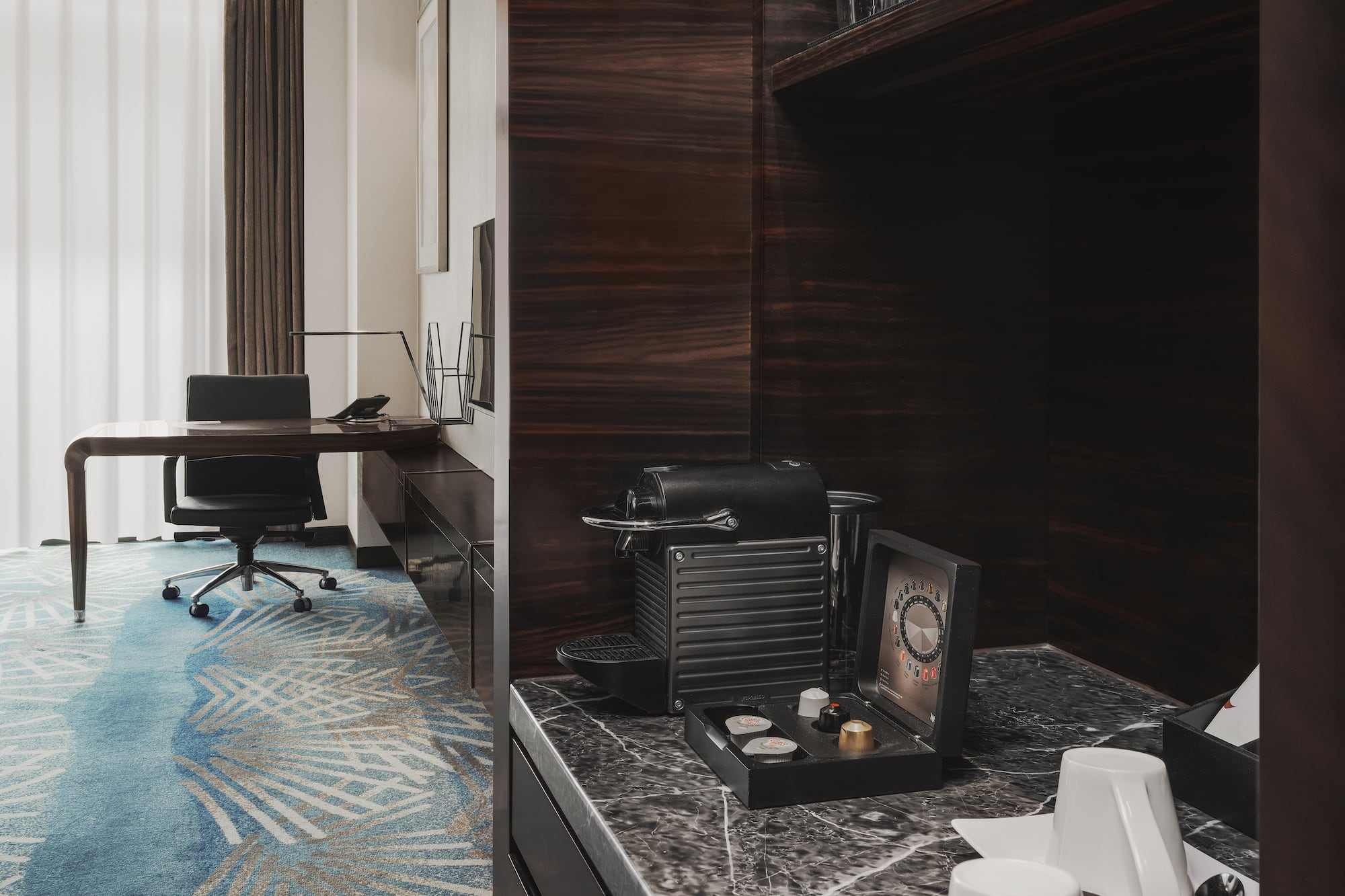 a room with a desk and a coffee machine