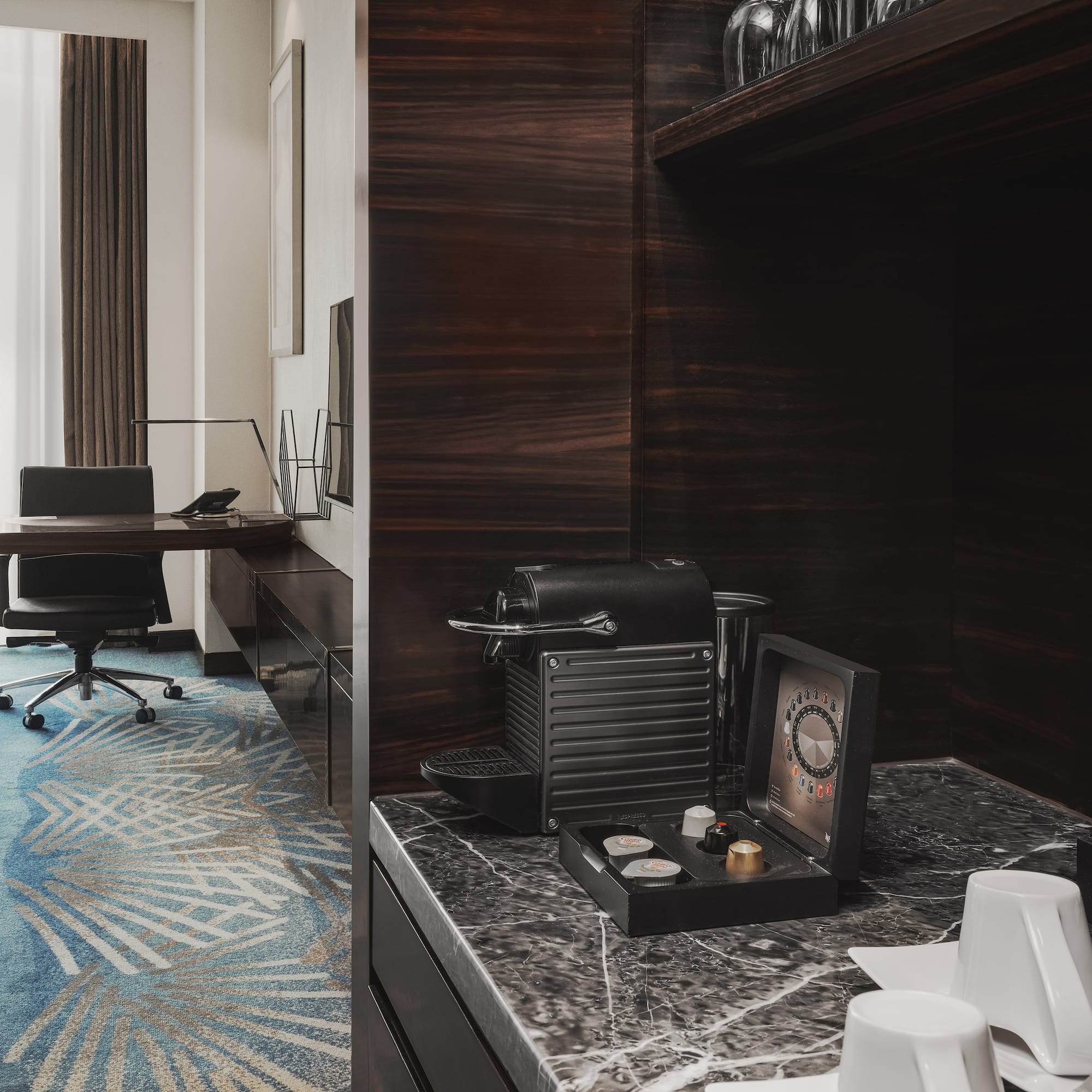 a room with a desk and a coffee machine