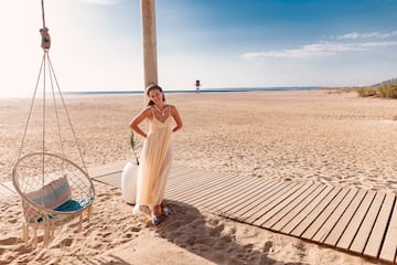 a woman in a dress on a beach