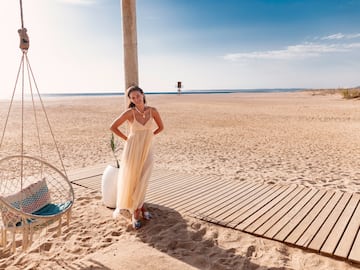 a woman in a dress on a beach