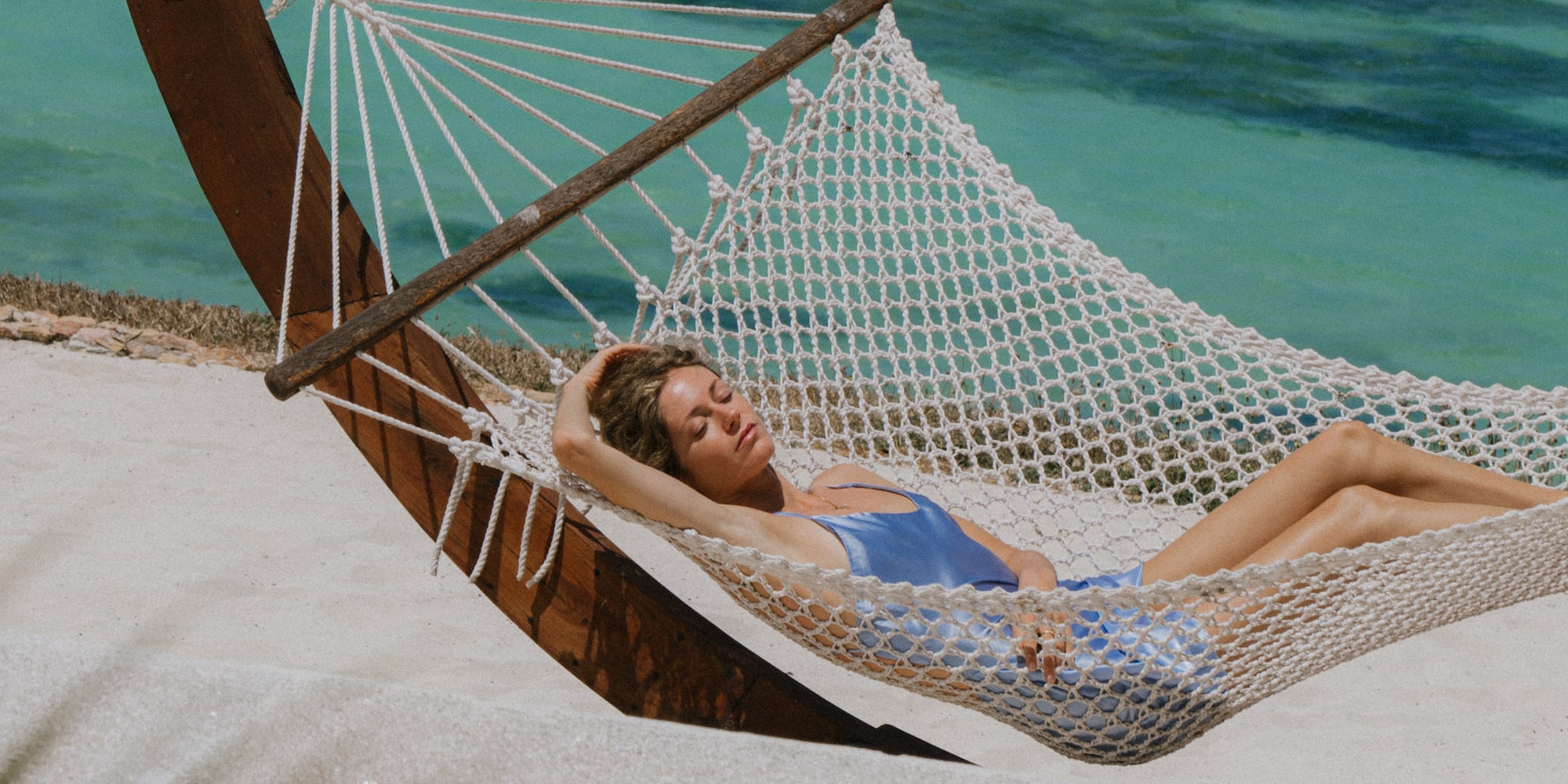a woman lying in a hammock