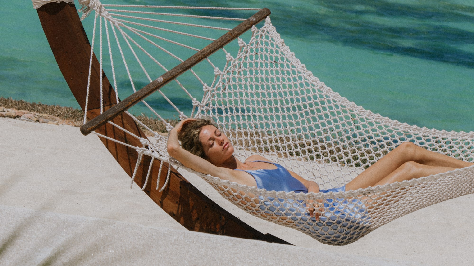 a woman lying in a hammock