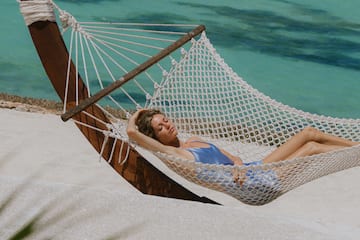 a woman lying in a hammock