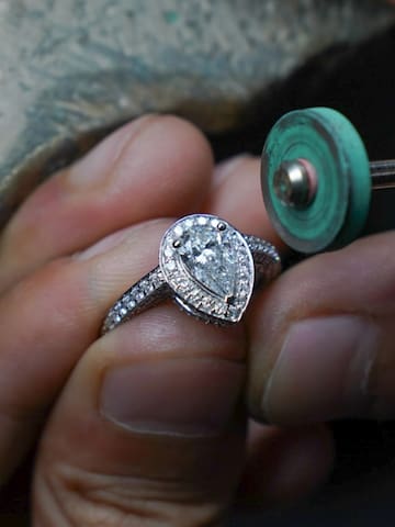 a person polishing a ring