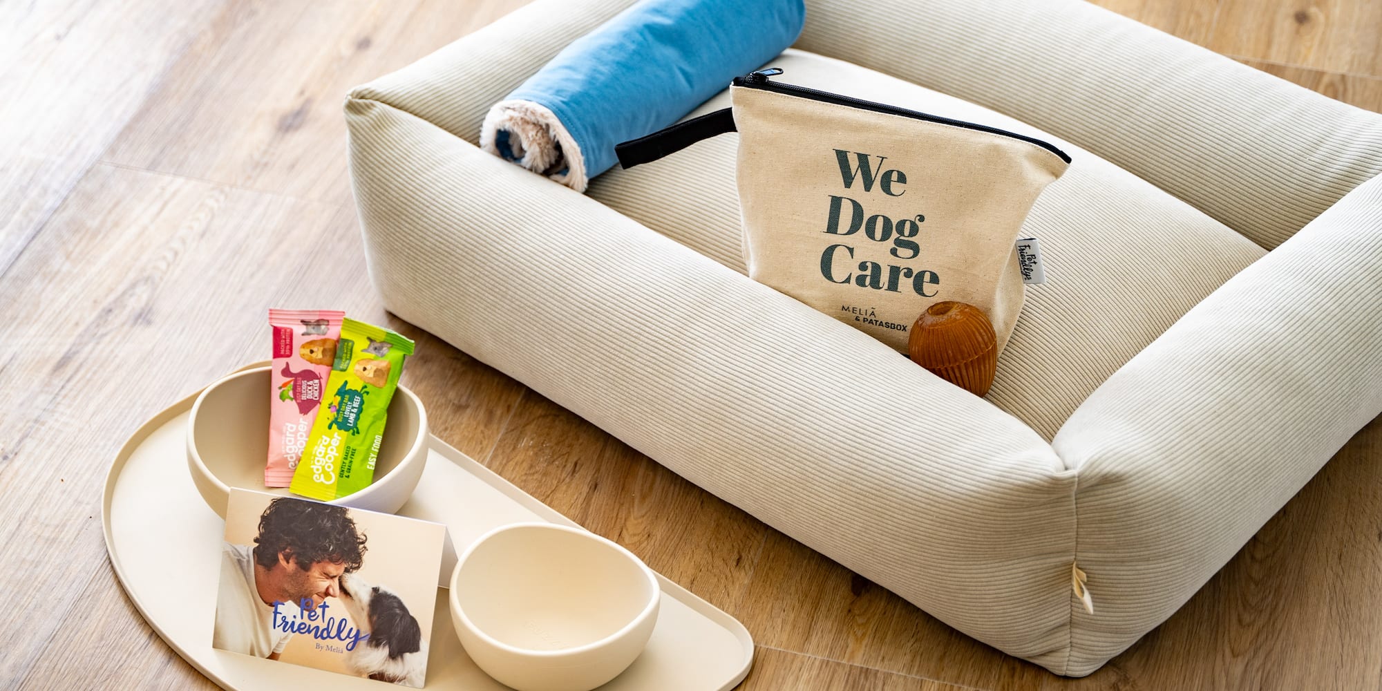 a dog bed with food and a bag on it
