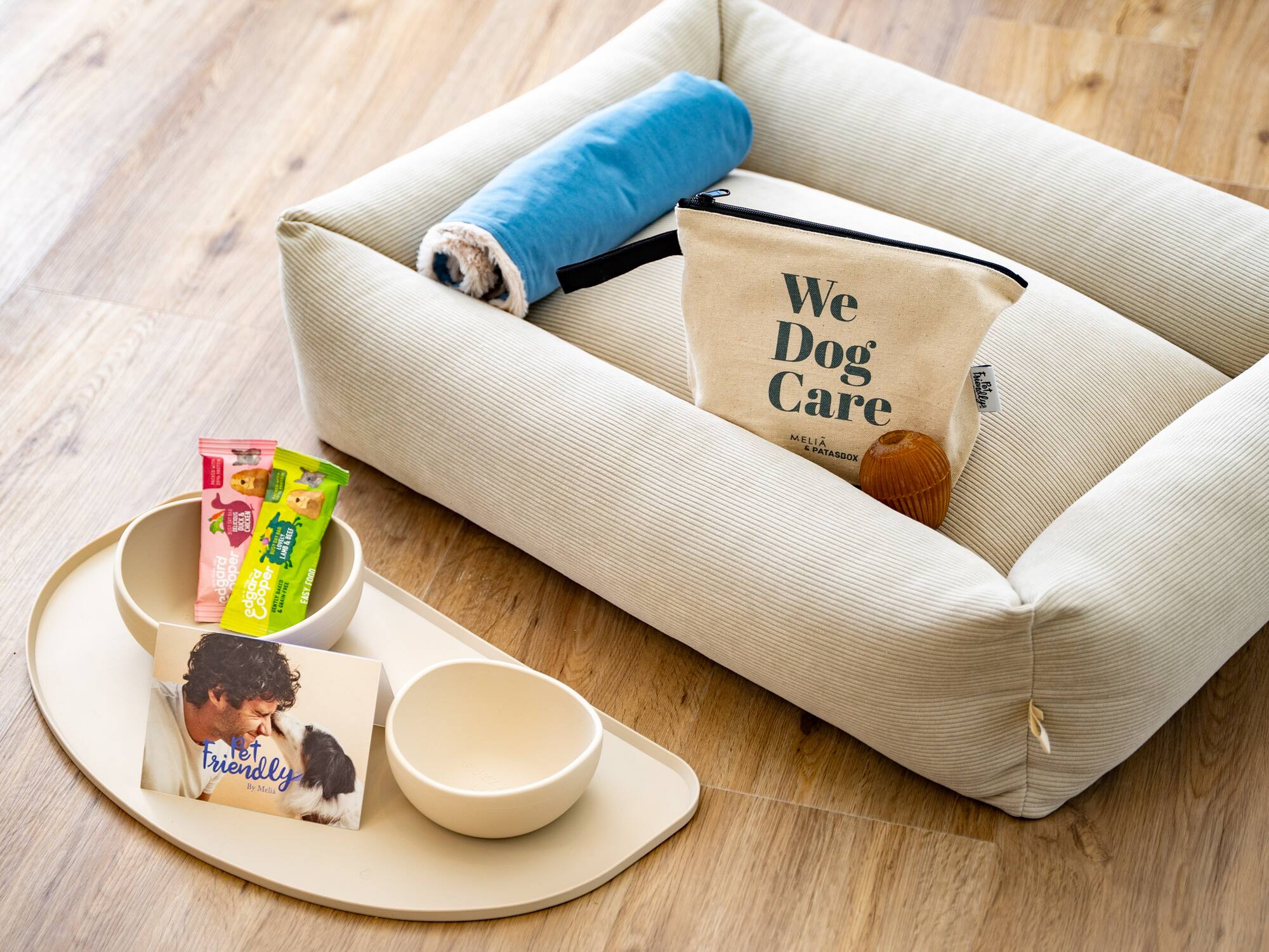 a dog bed with food and a bag on it