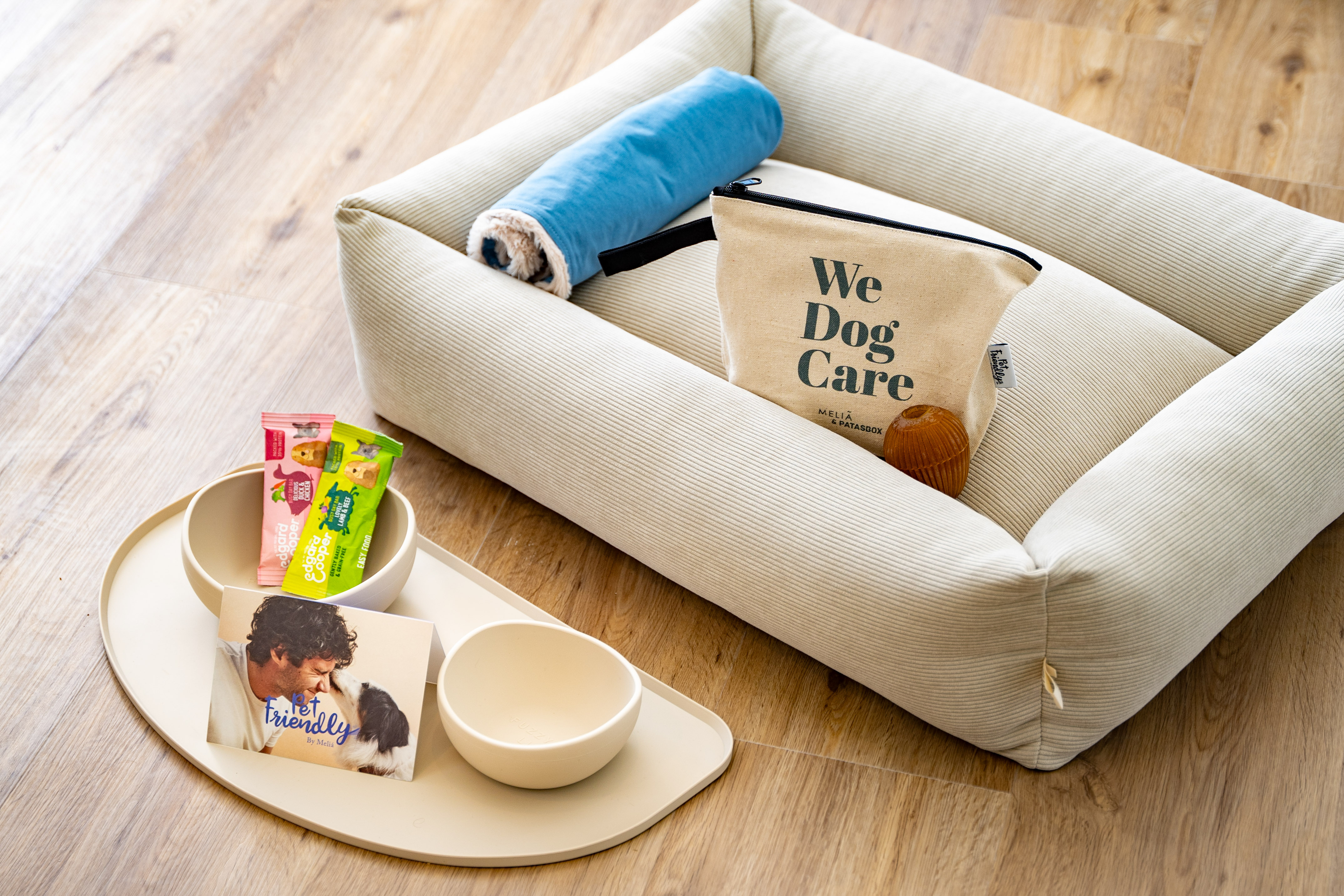 a dog bed with food and a bag on it
