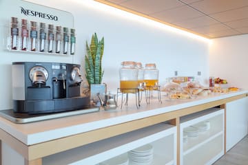 a coffee machine and drinks on a counter