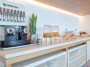 a coffee machine and drinks on a counter