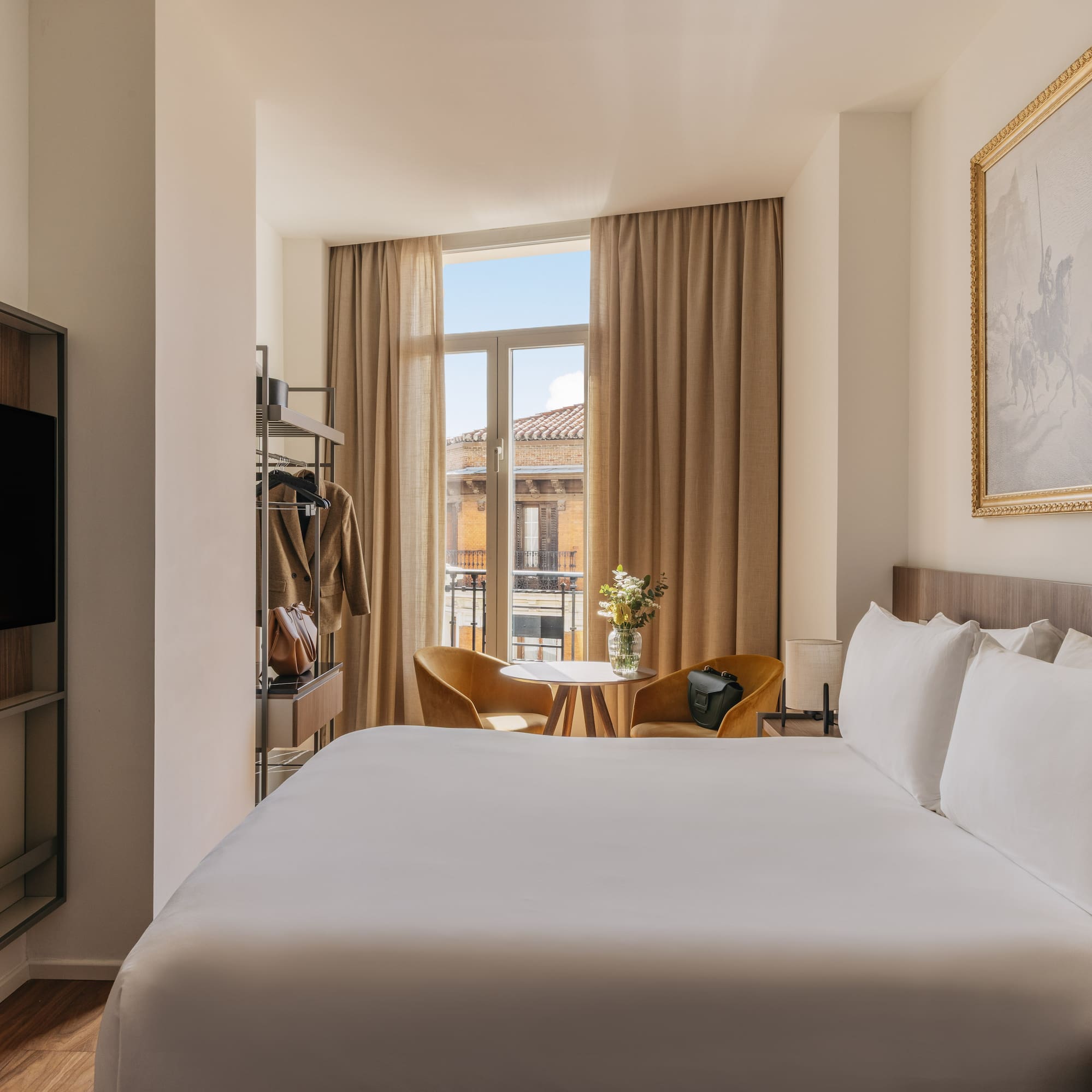 a room with a bed and a television