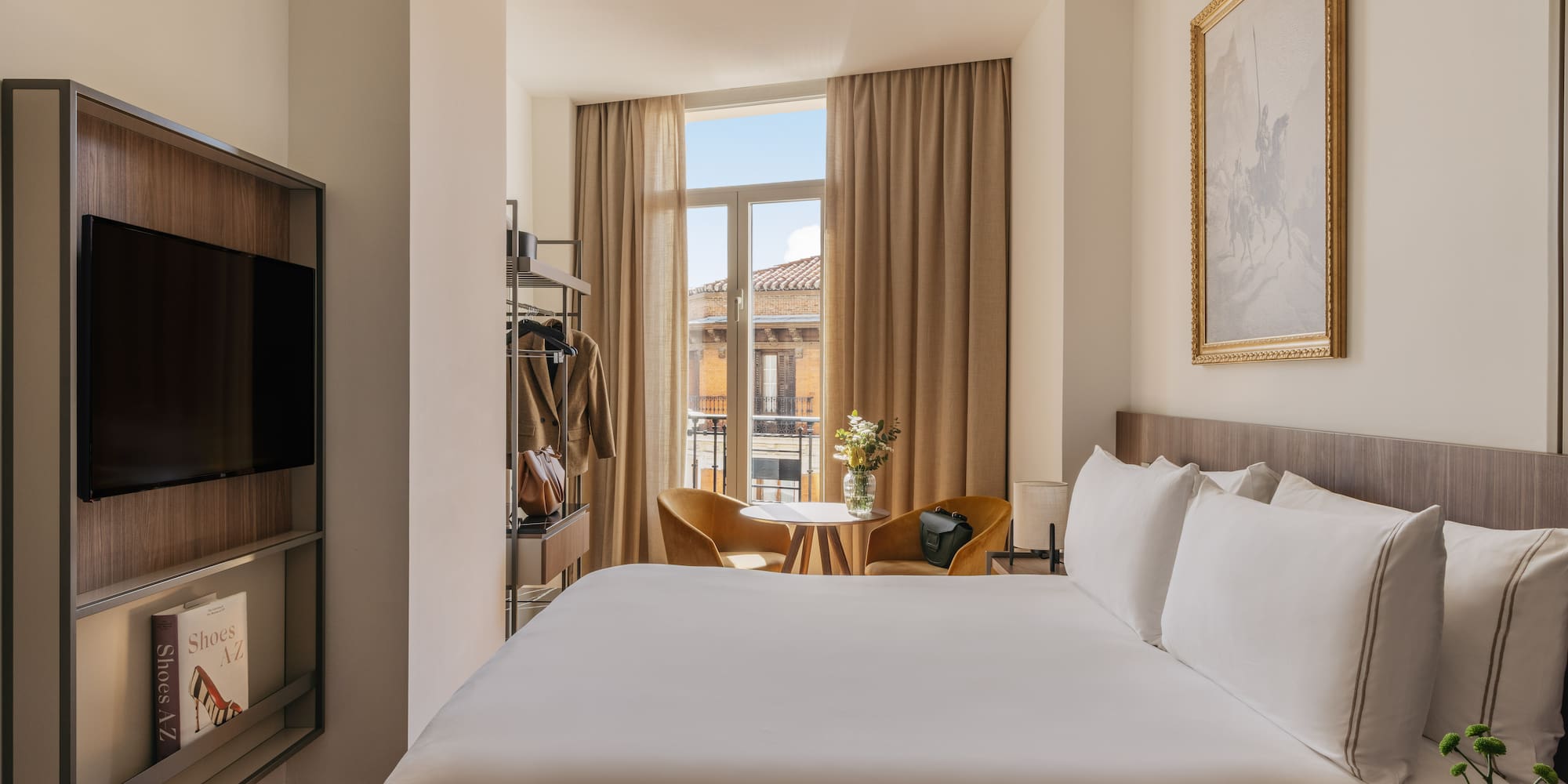 a room with a bed and a television