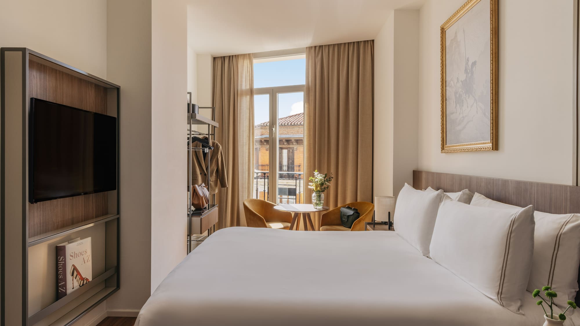 a room with a bed and a television