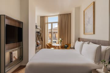 a room with a bed and a television