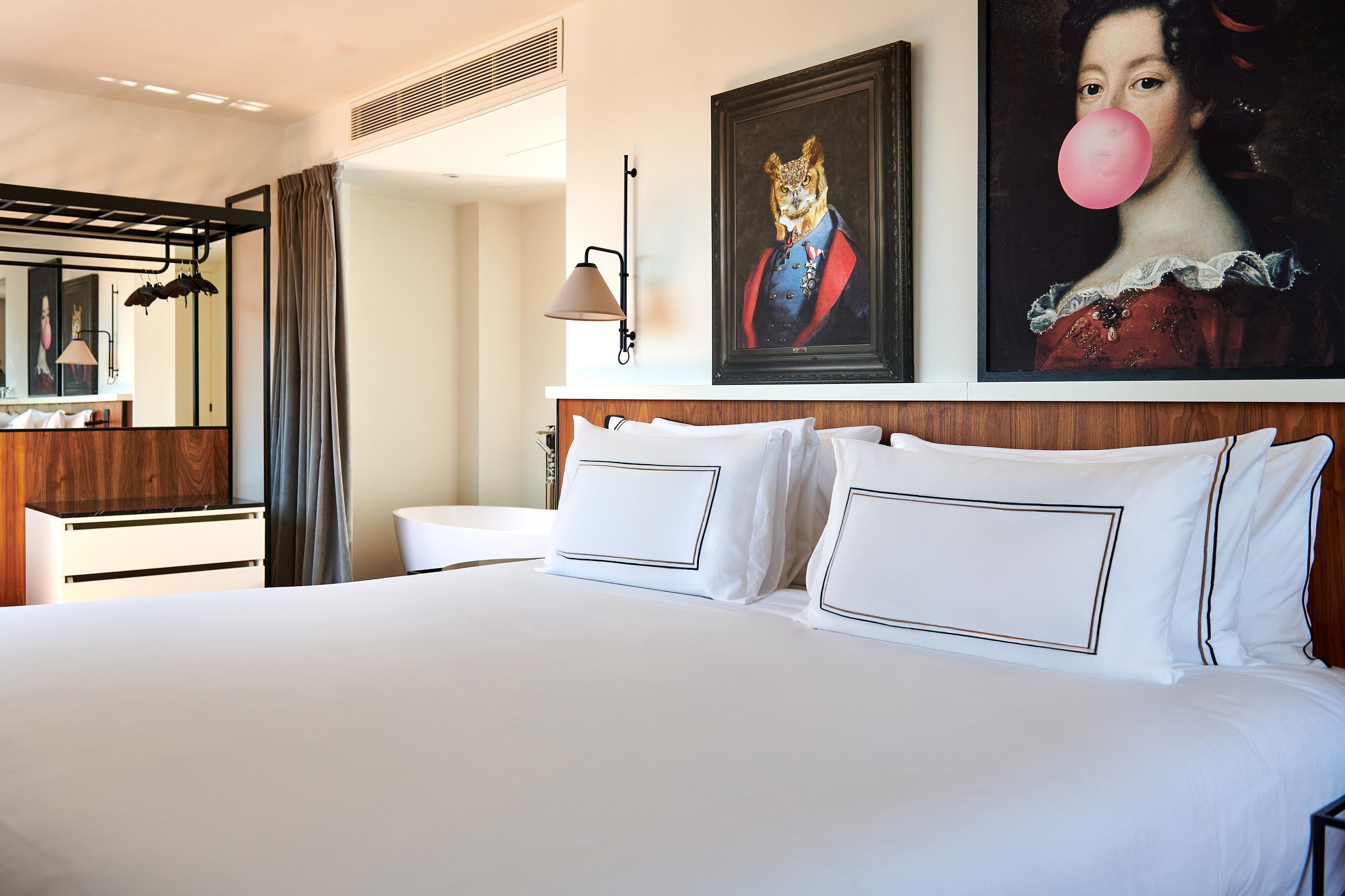 a bed with pillows and a painting of a tiger