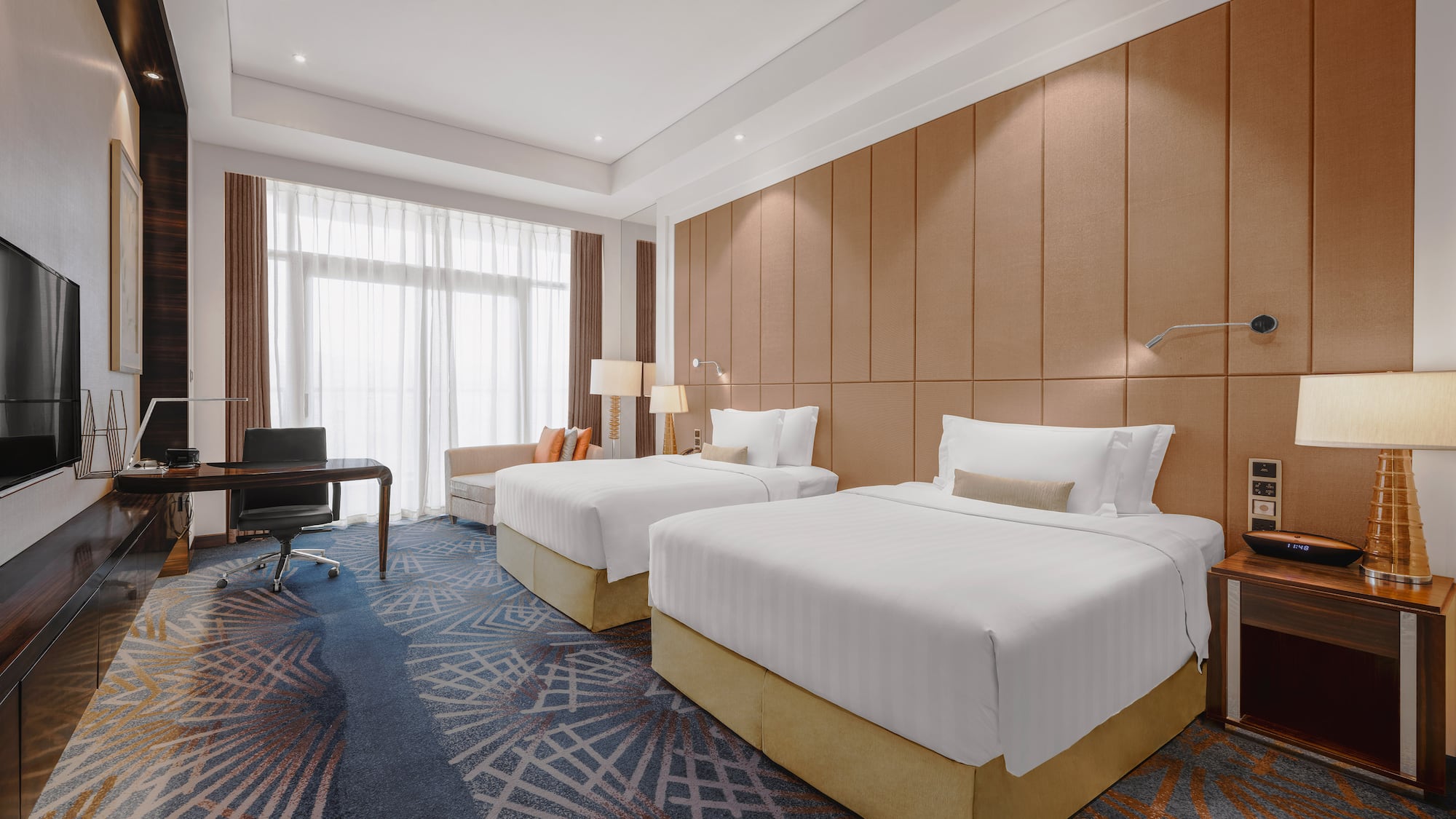 a room with two beds and a desk