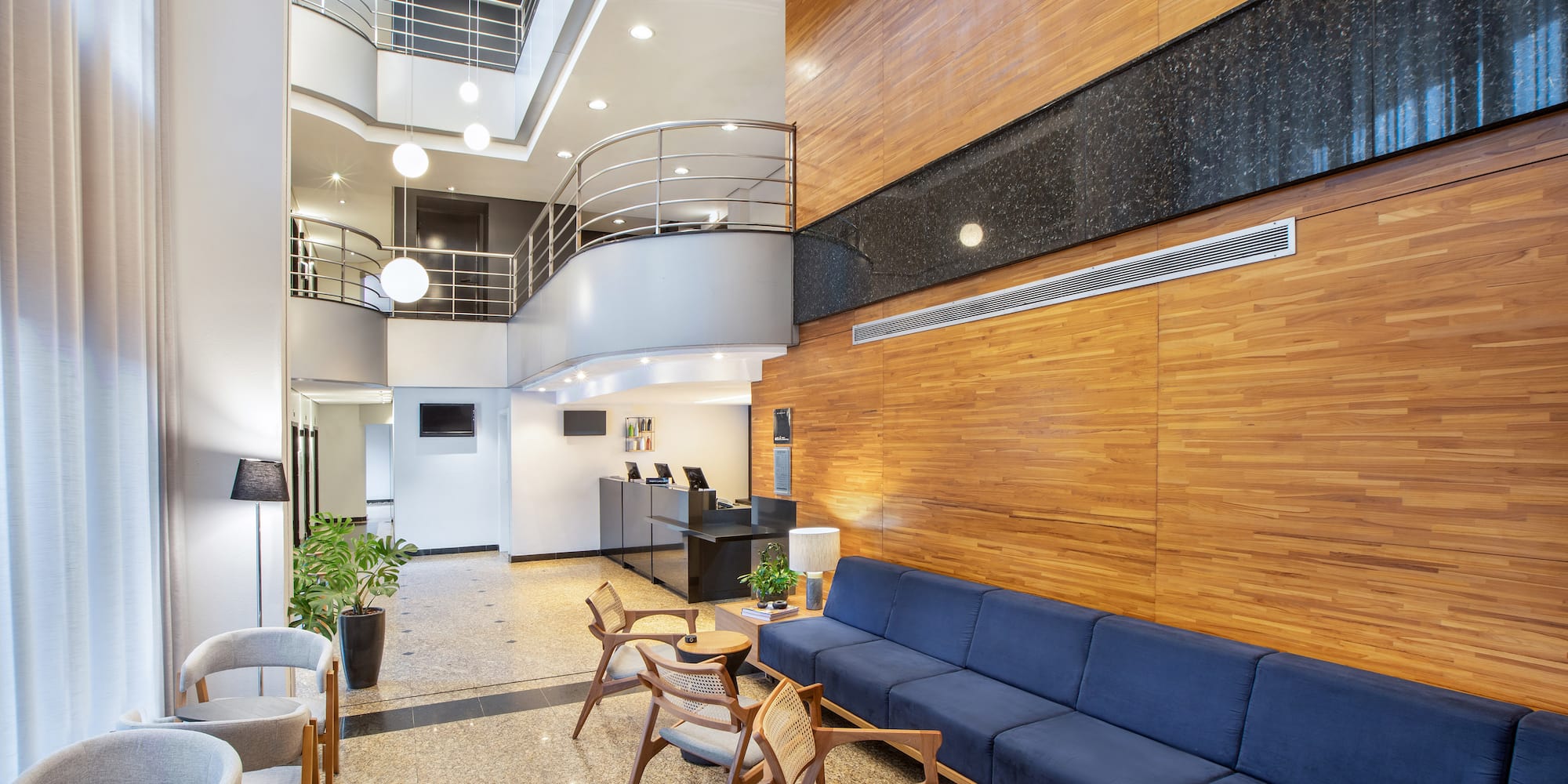 a room with a couch and chairs