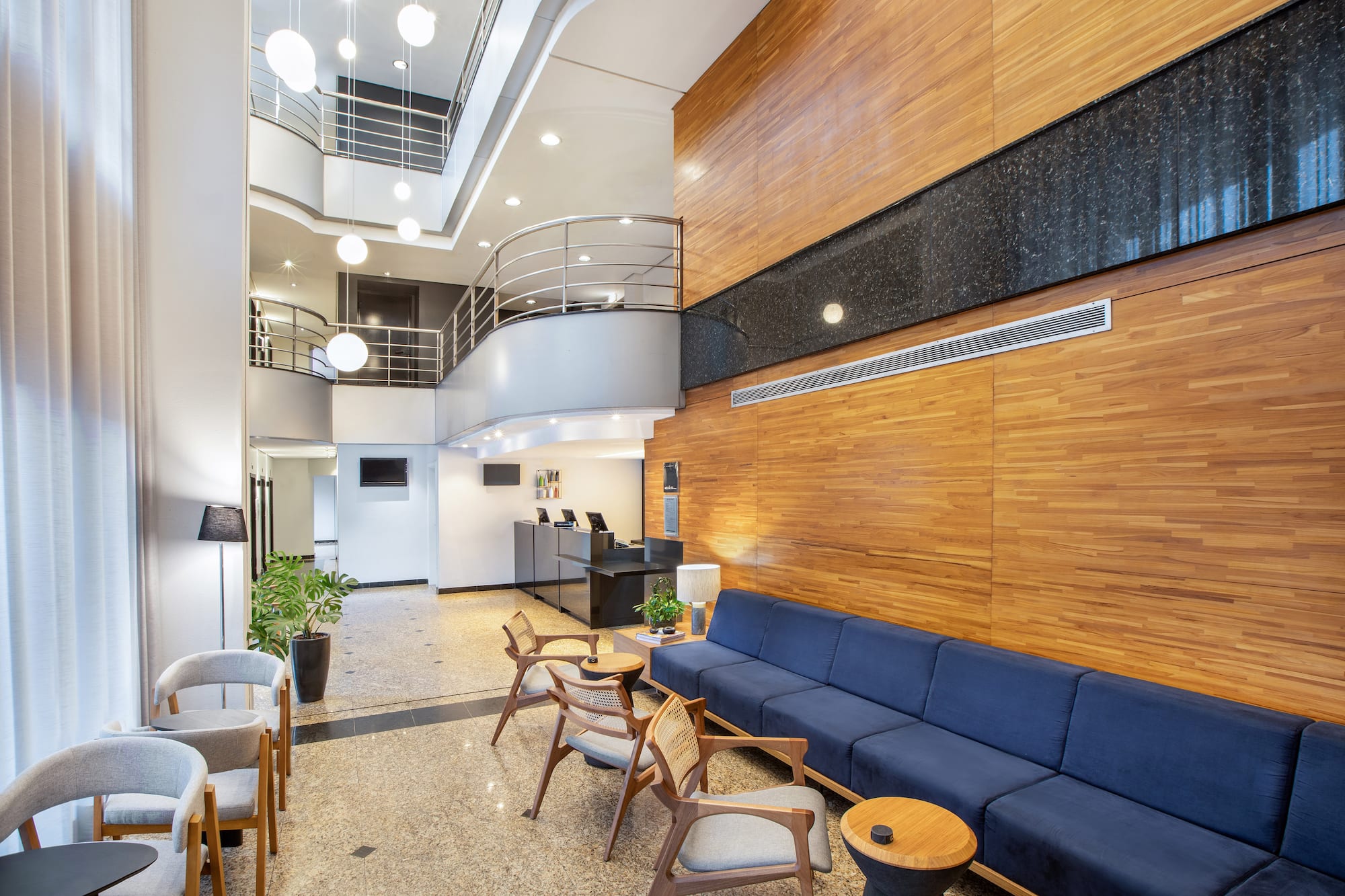 a room with a couch and chairs