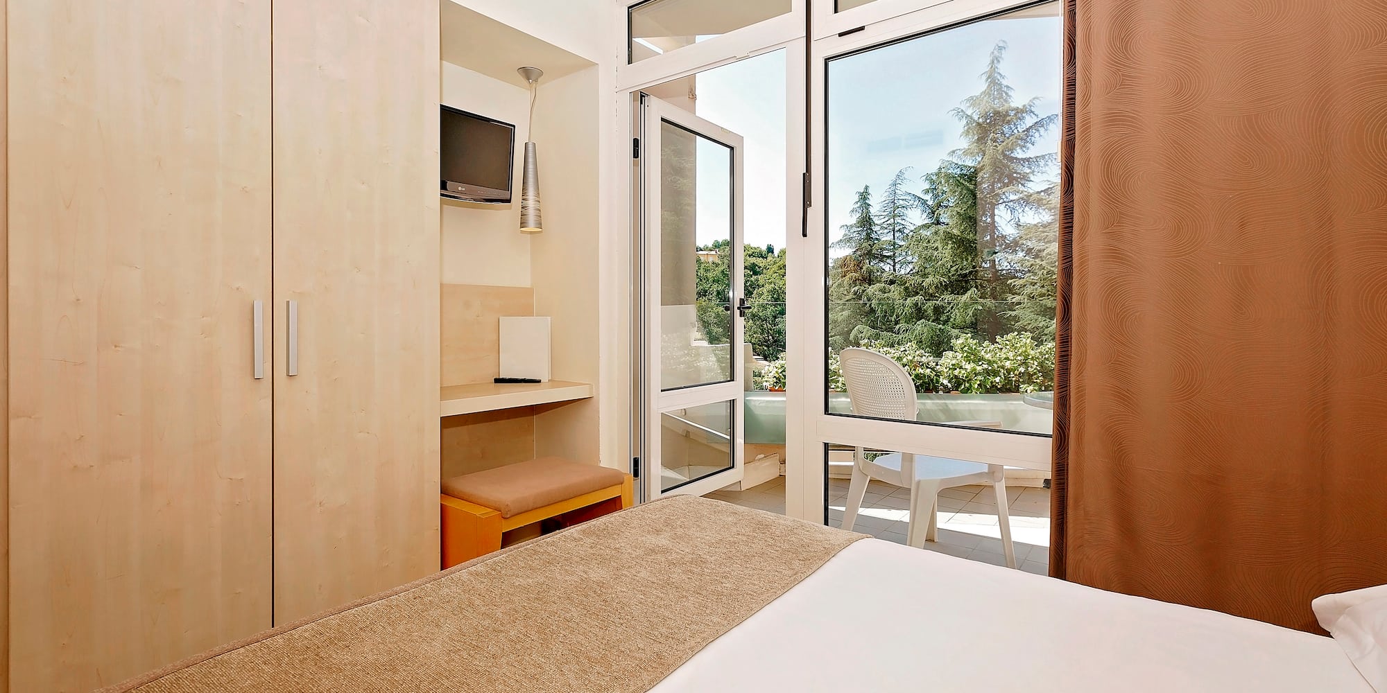 a bedroom with a door open to a patio