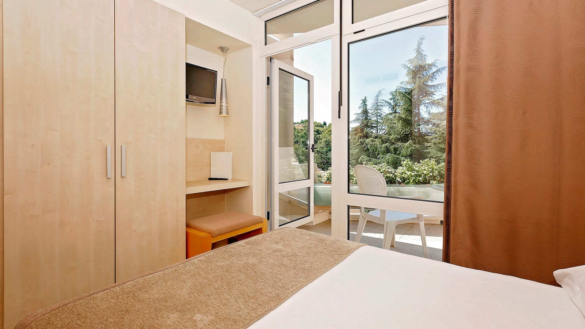 a bedroom with a door open to a patio