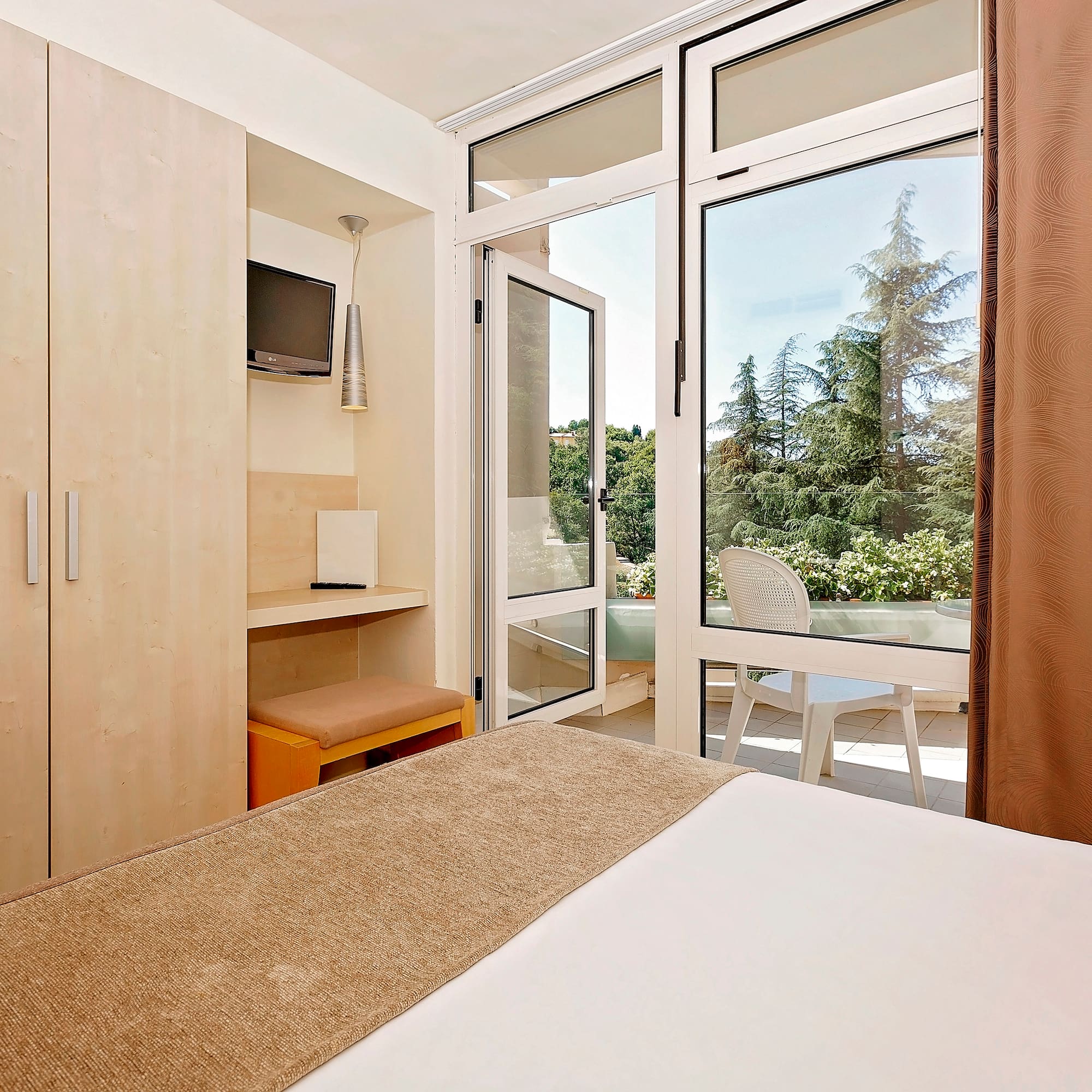 a bedroom with a door open to a patio