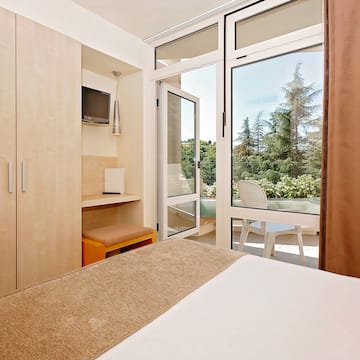 a bedroom with a door open to a patio