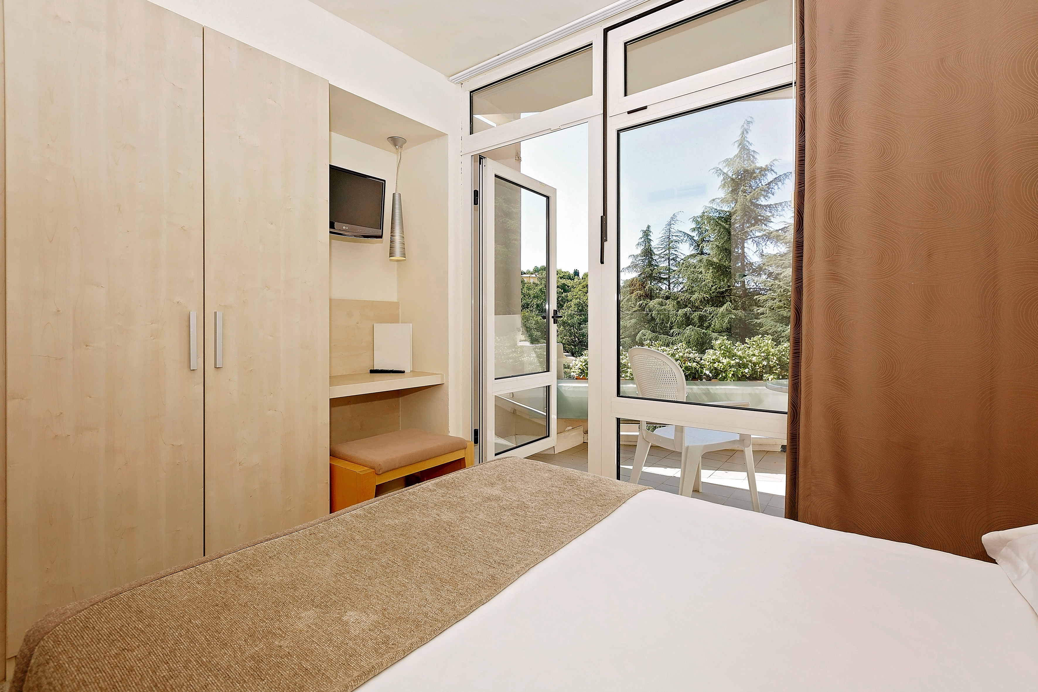 a bedroom with a door open to a patio