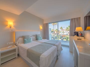 a bedroom with a double bed and a window