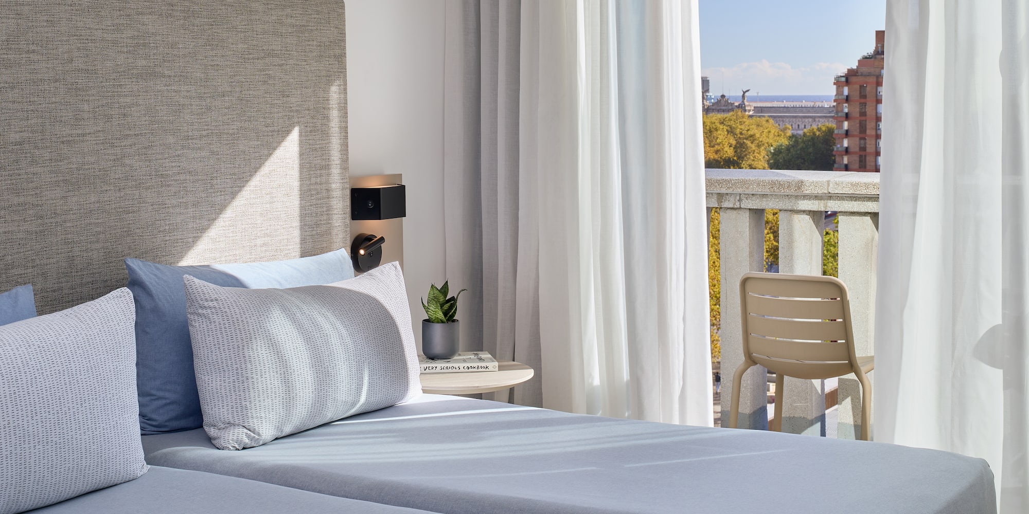 a bed with a chair and a table in front of it