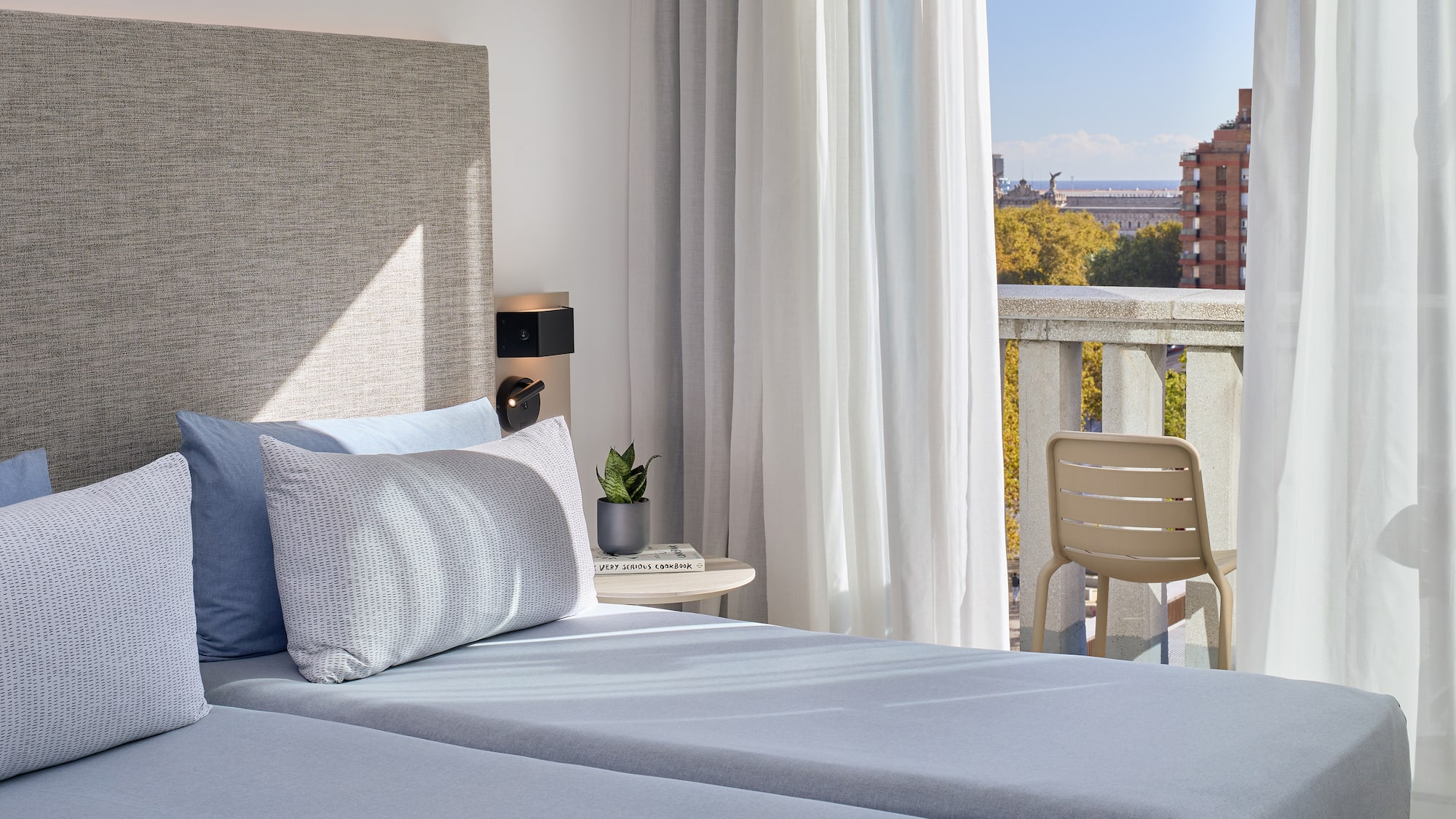 a bed with a chair and a table in front of it