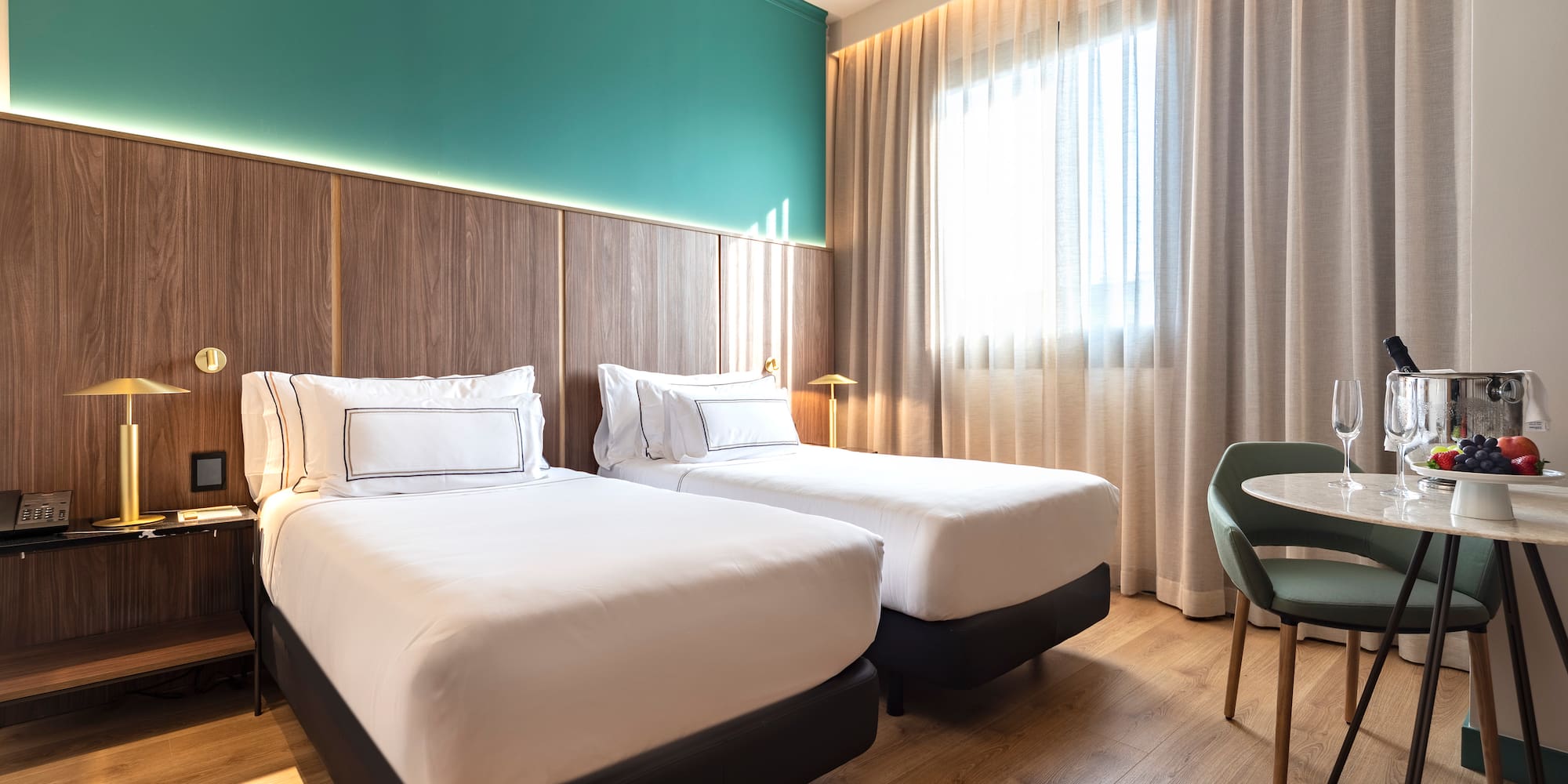 a room with two beds and a table