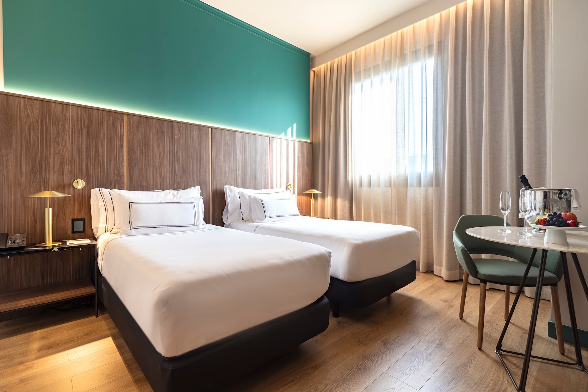 a room with two beds and a table