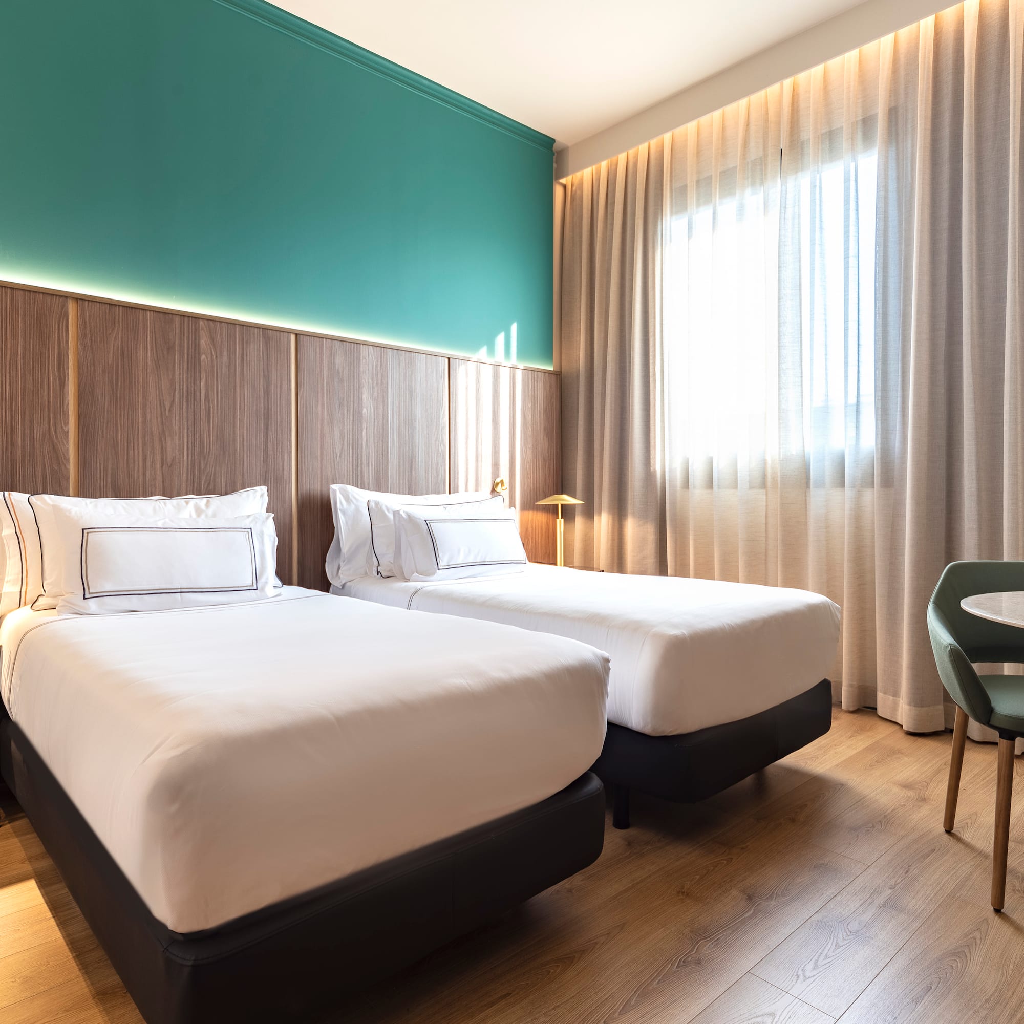 a room with two beds and a table