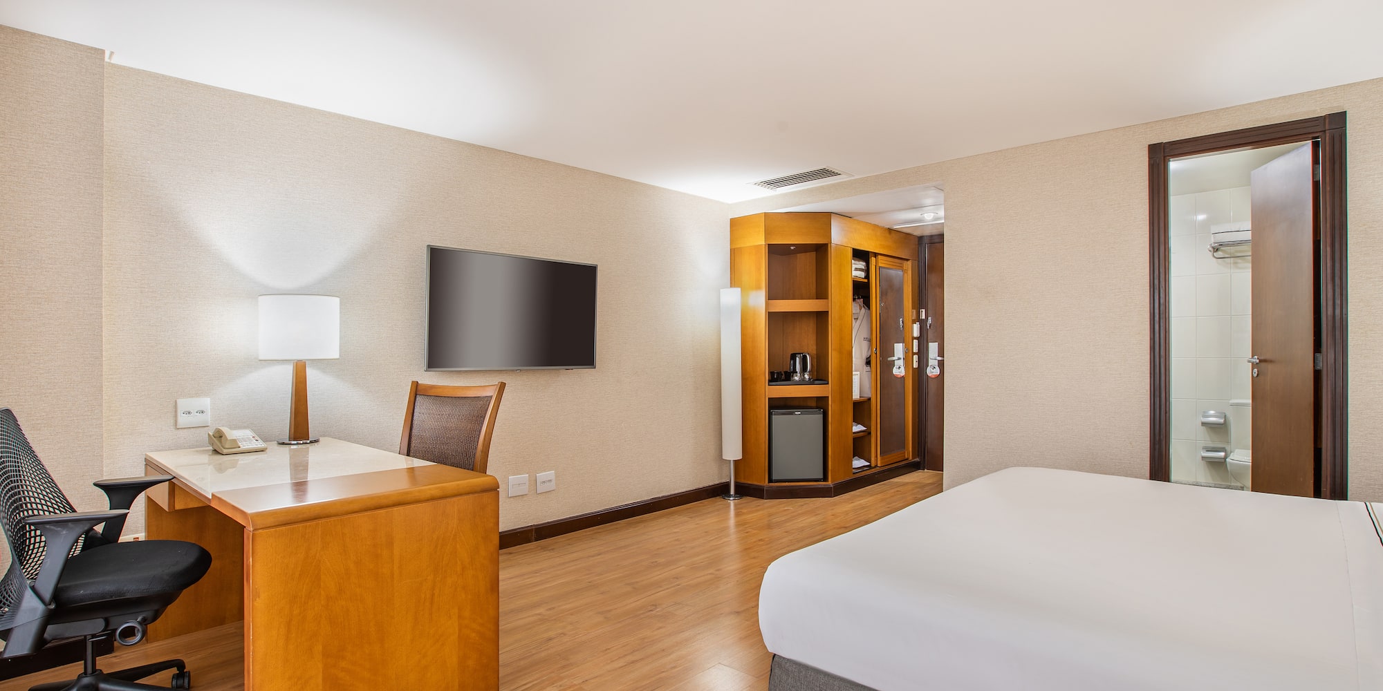 a room with a desk and a bed