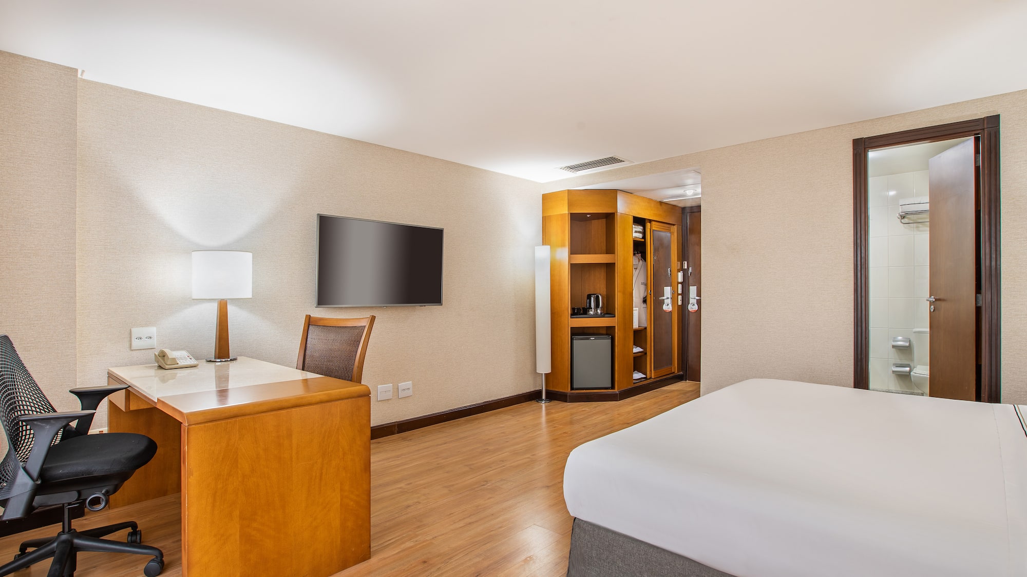 a room with a desk and a bed