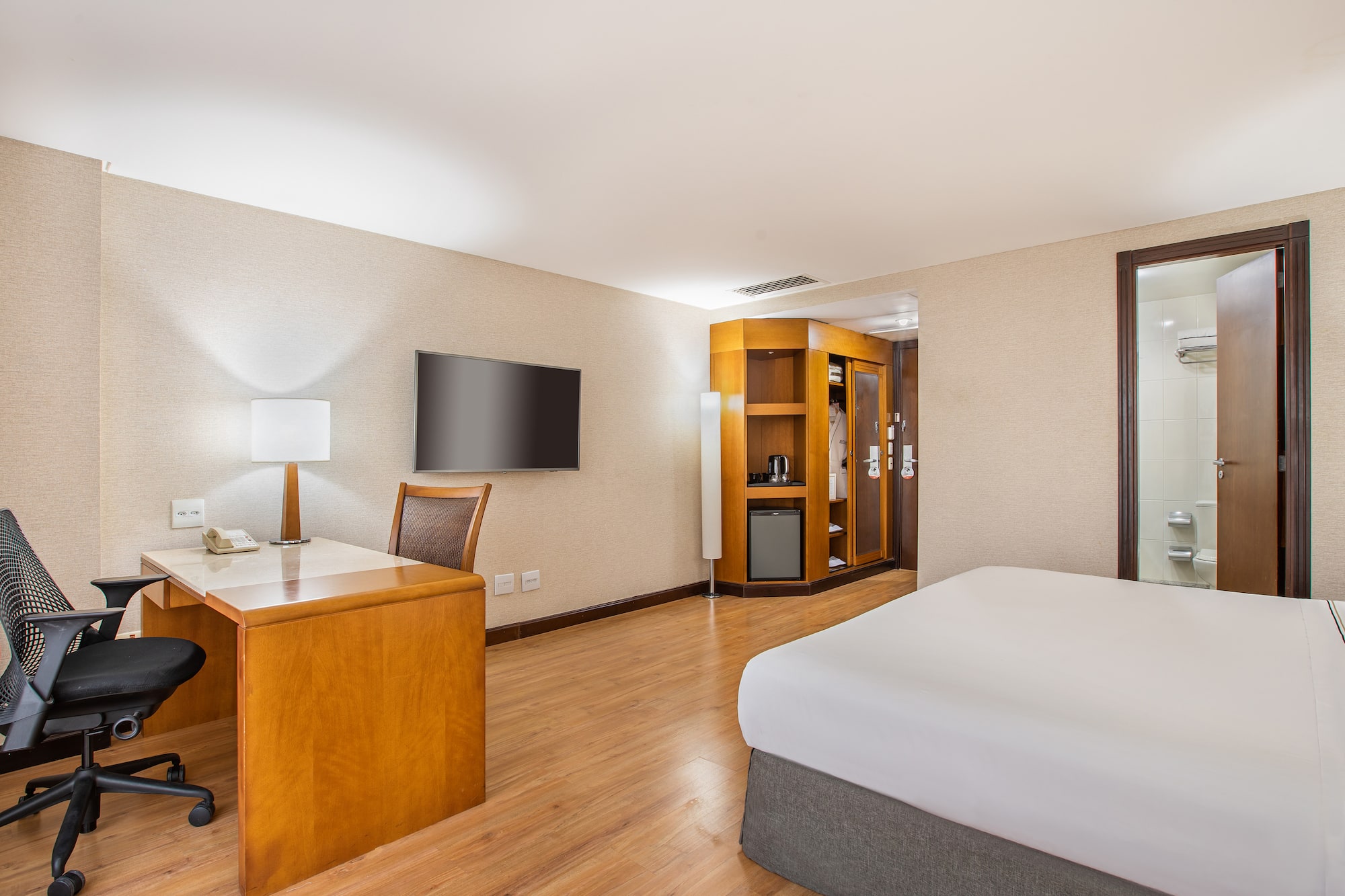 a room with a desk and a bed