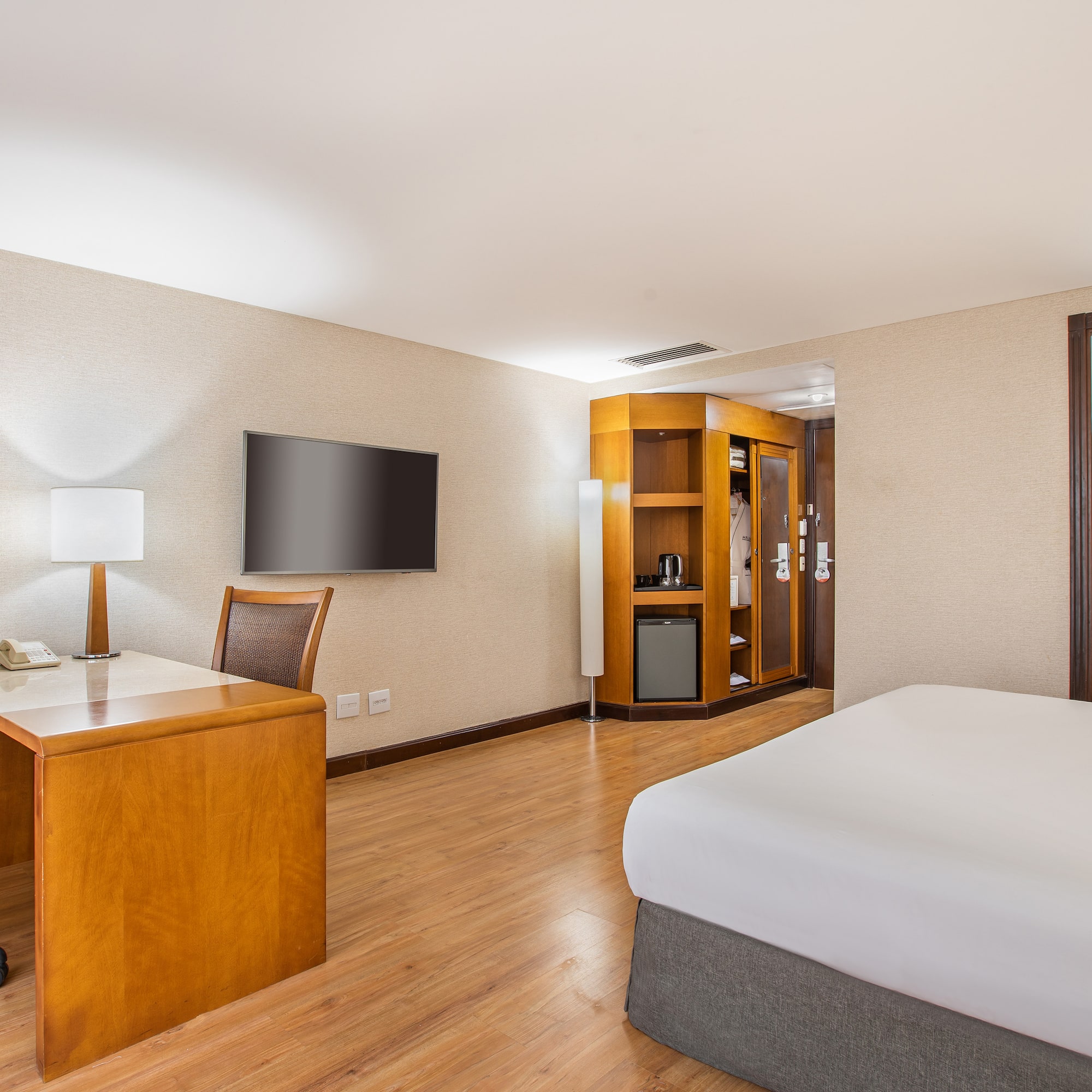 a room with a desk and a bed