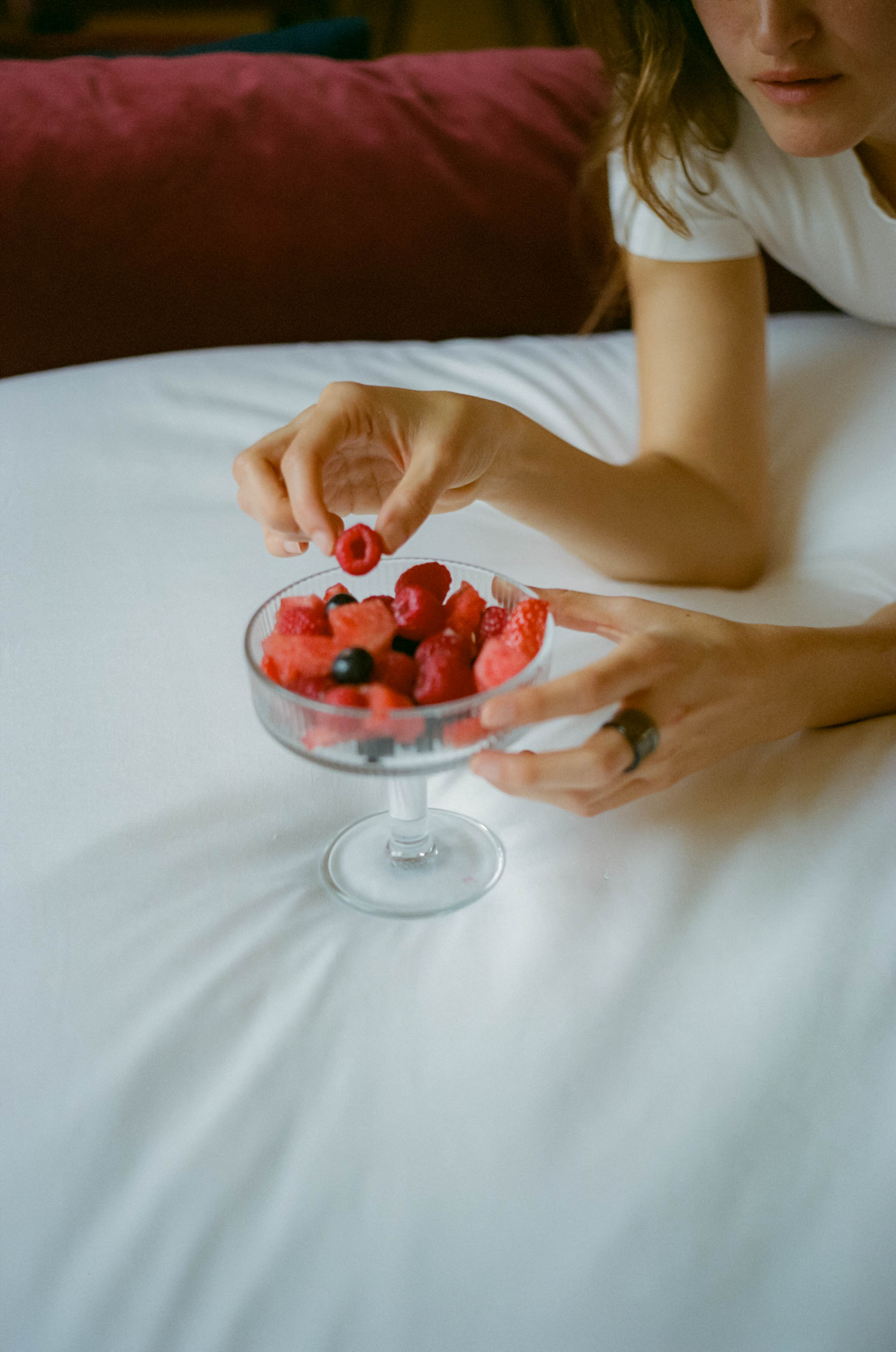 a person eating fruit in a bowl