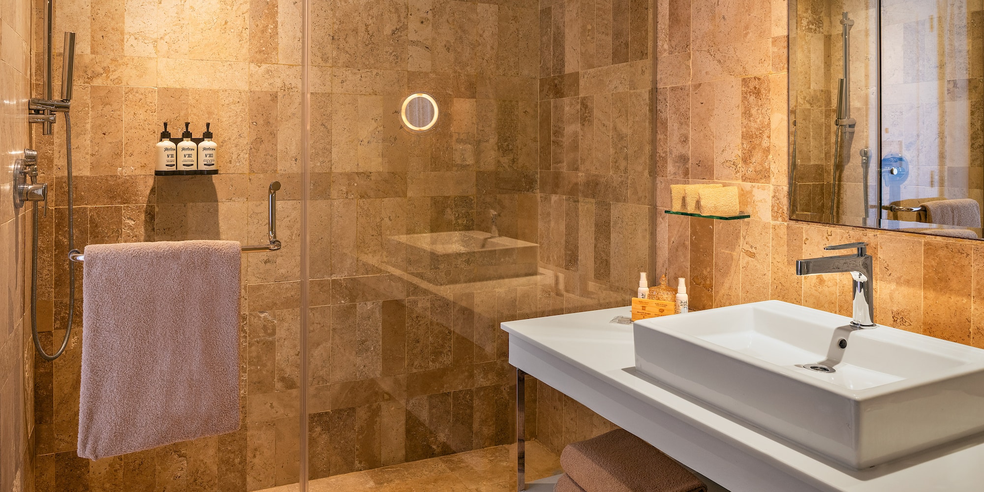 a bathroom with a glass shower and sink