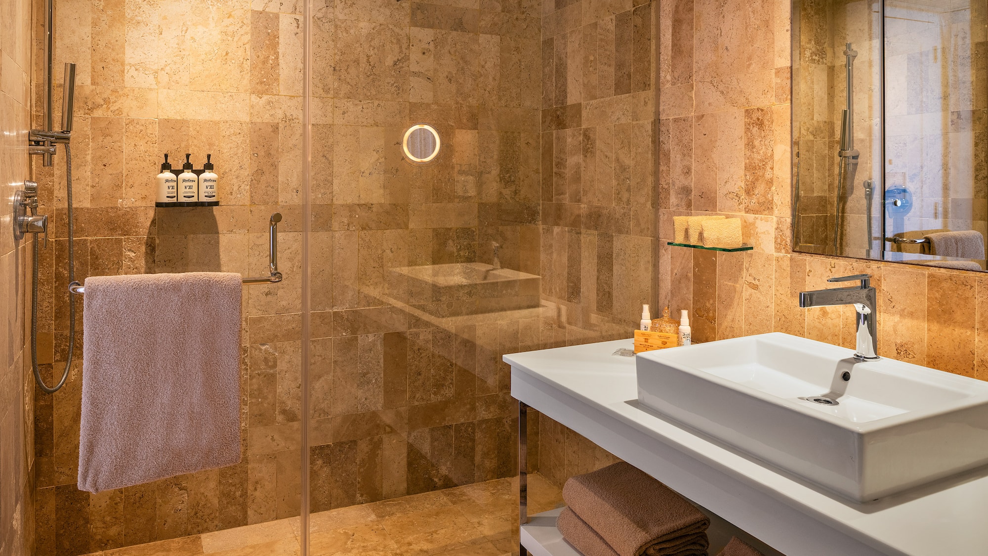 a bathroom with a glass shower and sink