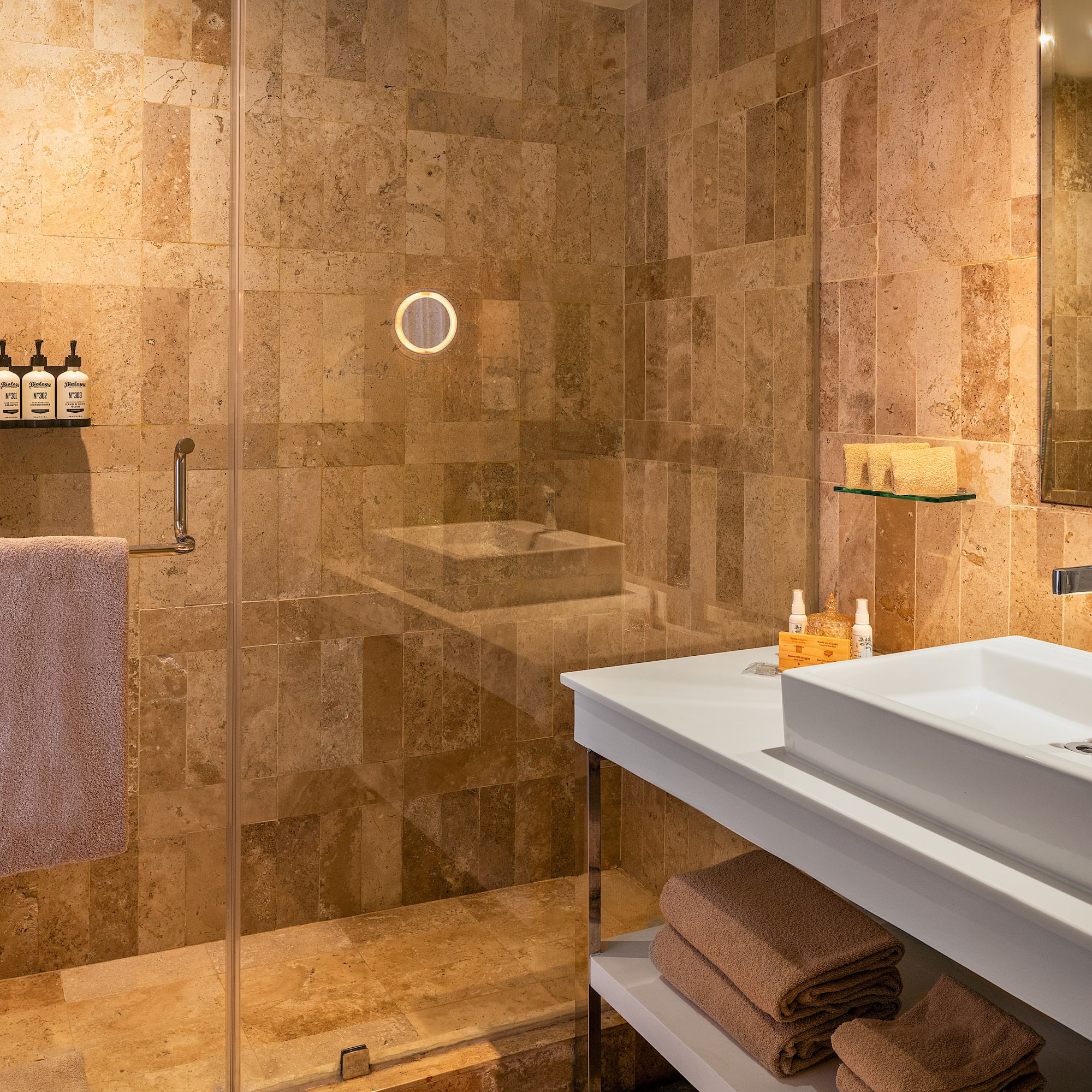 a bathroom with a glass shower and sink