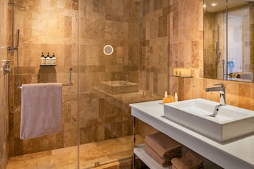 a bathroom with a glass shower and sink