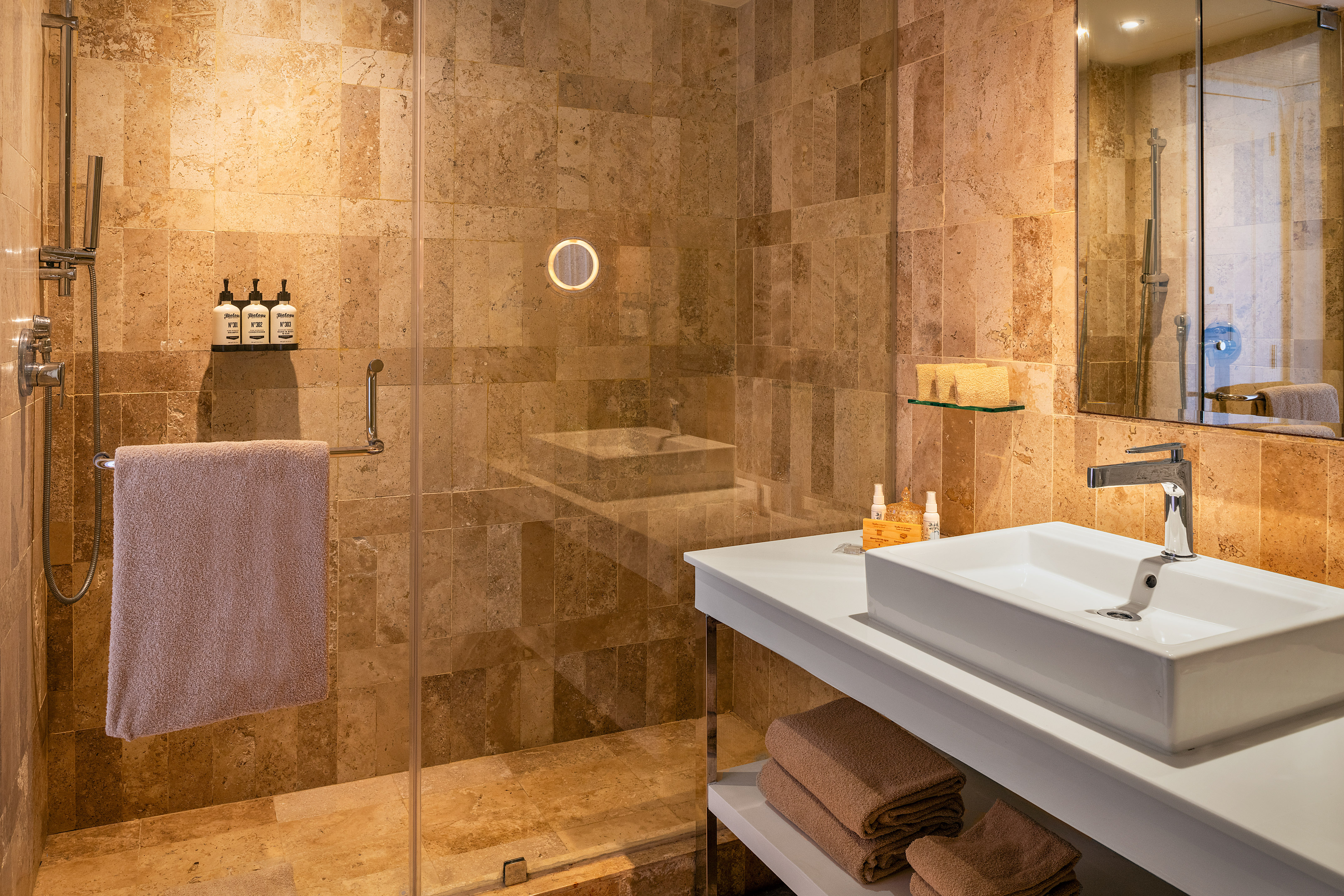 a bathroom with a glass shower and sink