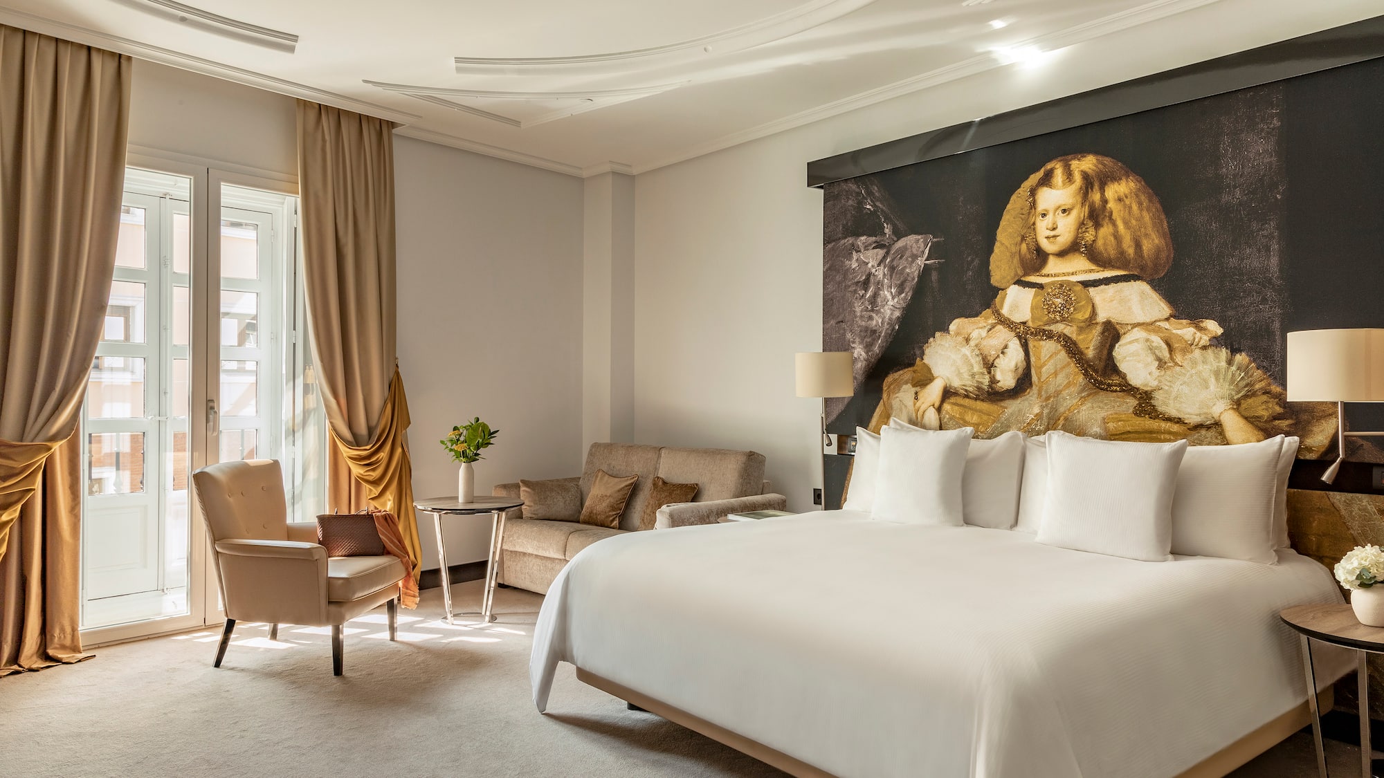 a room with a bed and chairs