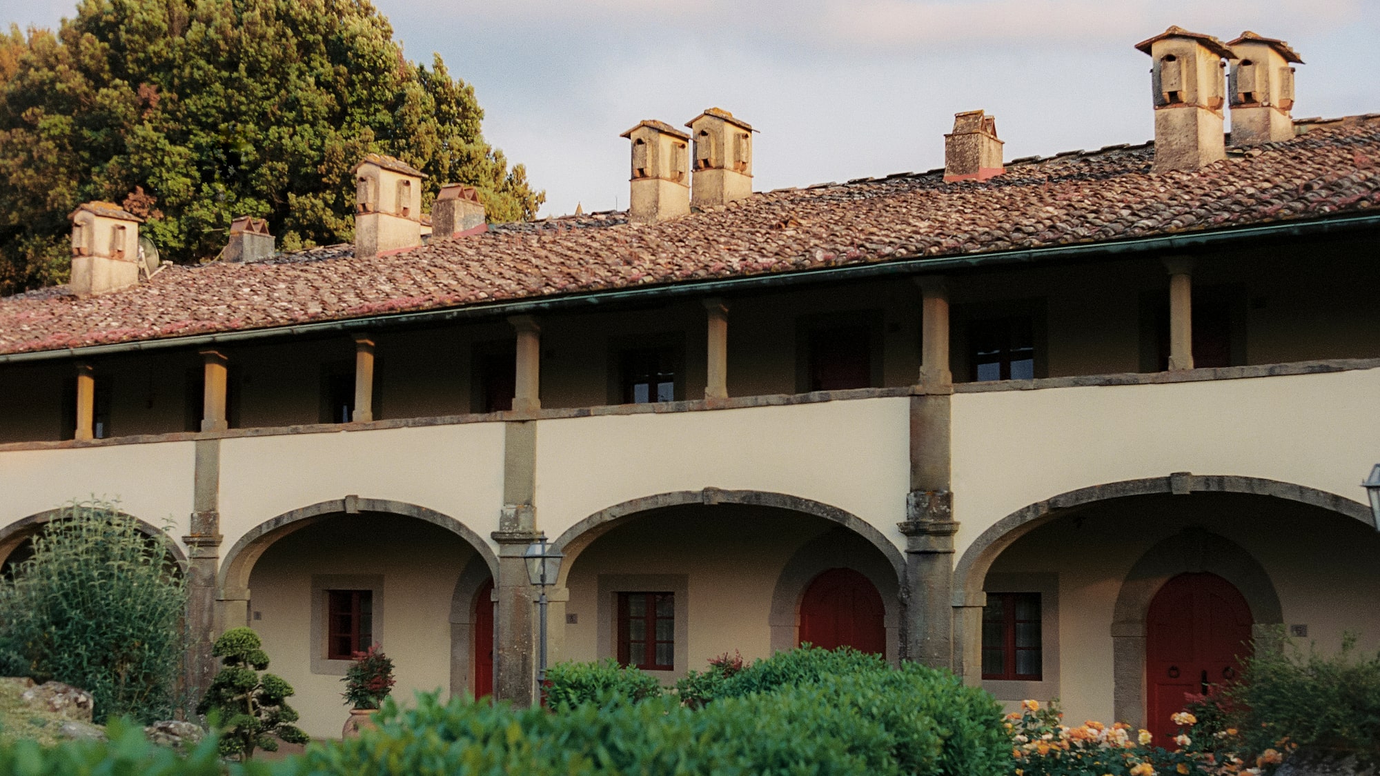 a building with many arches and a garden