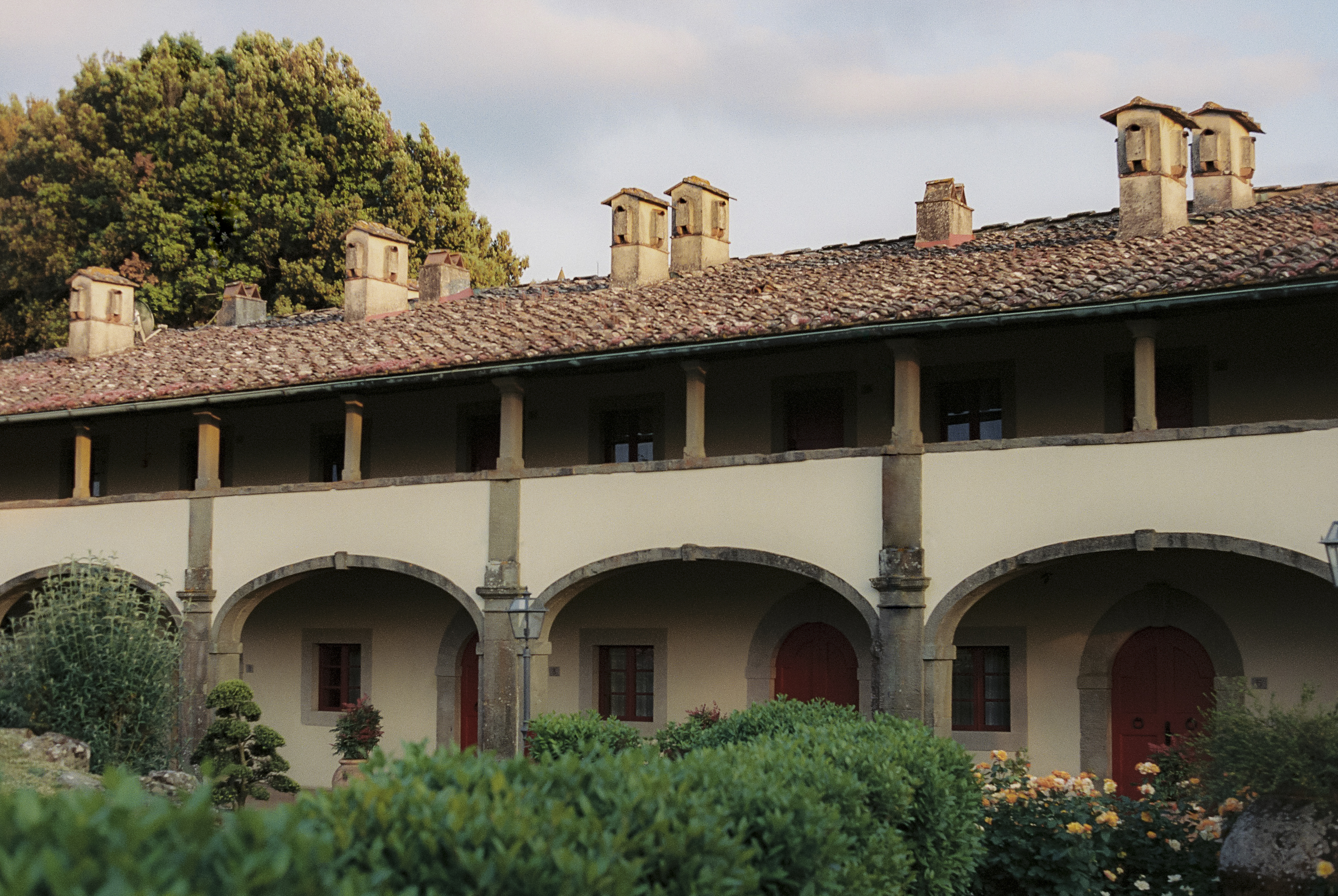 a building with many arches and a garden