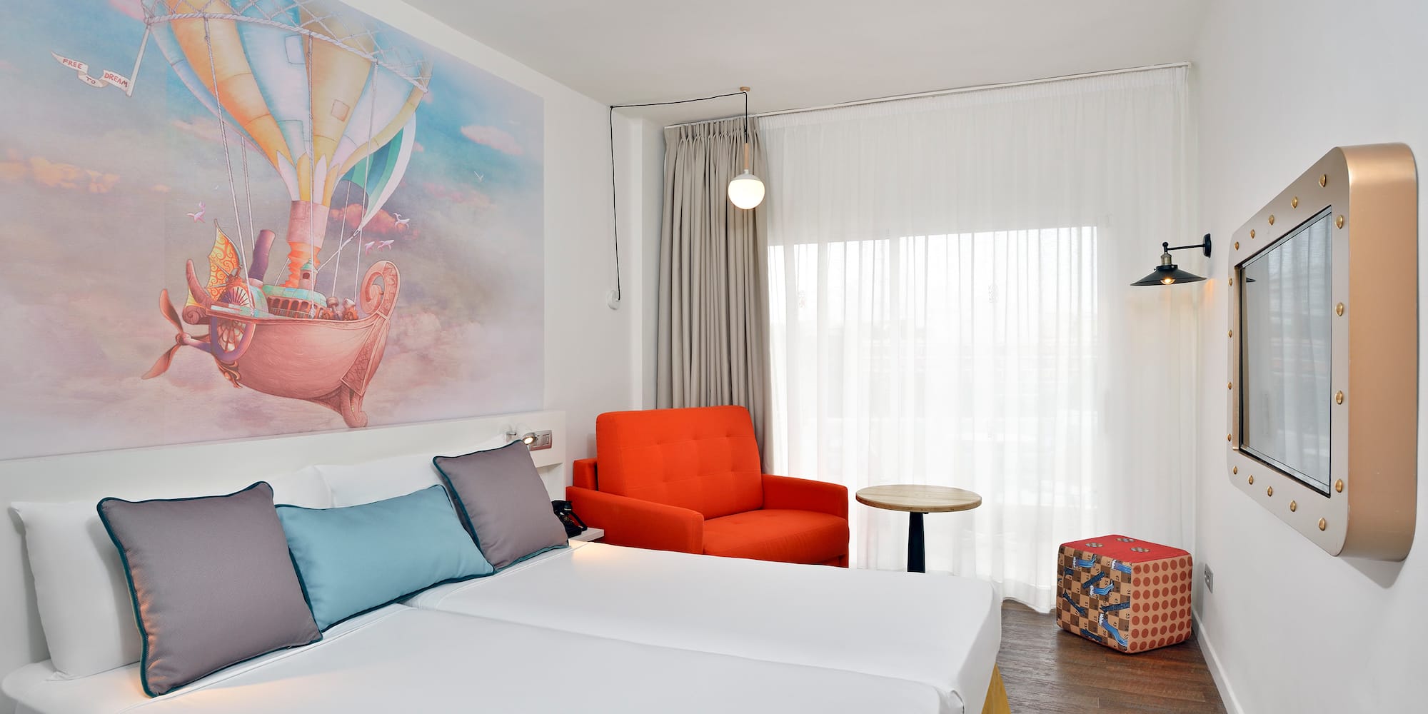 a room with two beds and a chair