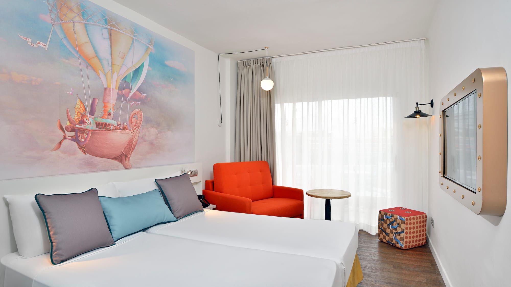 a room with two beds and a chair